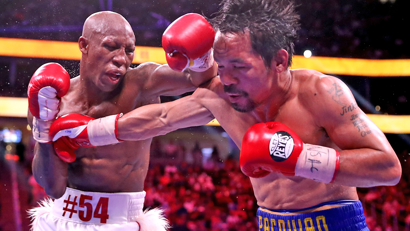 Manny Pacquiao takes a punch from Yordenis Ugas during their WBA welterweight title fight at T-Mobile Arena