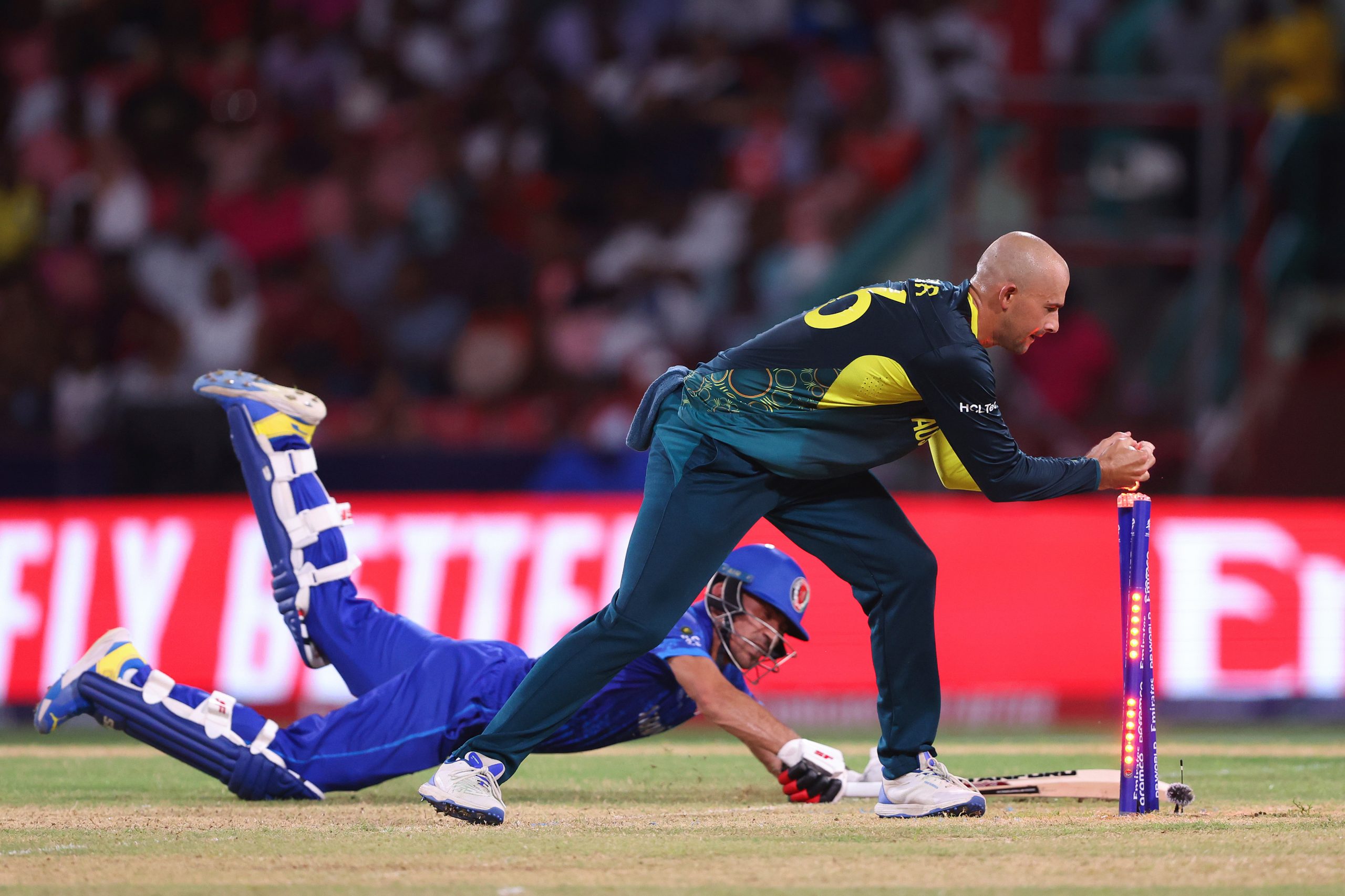 Ashton Agar of Australia attempts to runout Rahmanullah Gurbaz of Afghanistan as he makes his ground during the ICC Men's T20 Cricket World Cup West Indies & USA 2024 Super Eight match between Afghanistan and Australia at Arnos Vale Ground on June 22, 2024 in St Vincent, Saint Vincent and The Grenadines. (Photo by Darrian Traynor-ICC/ICC via Getty Images)