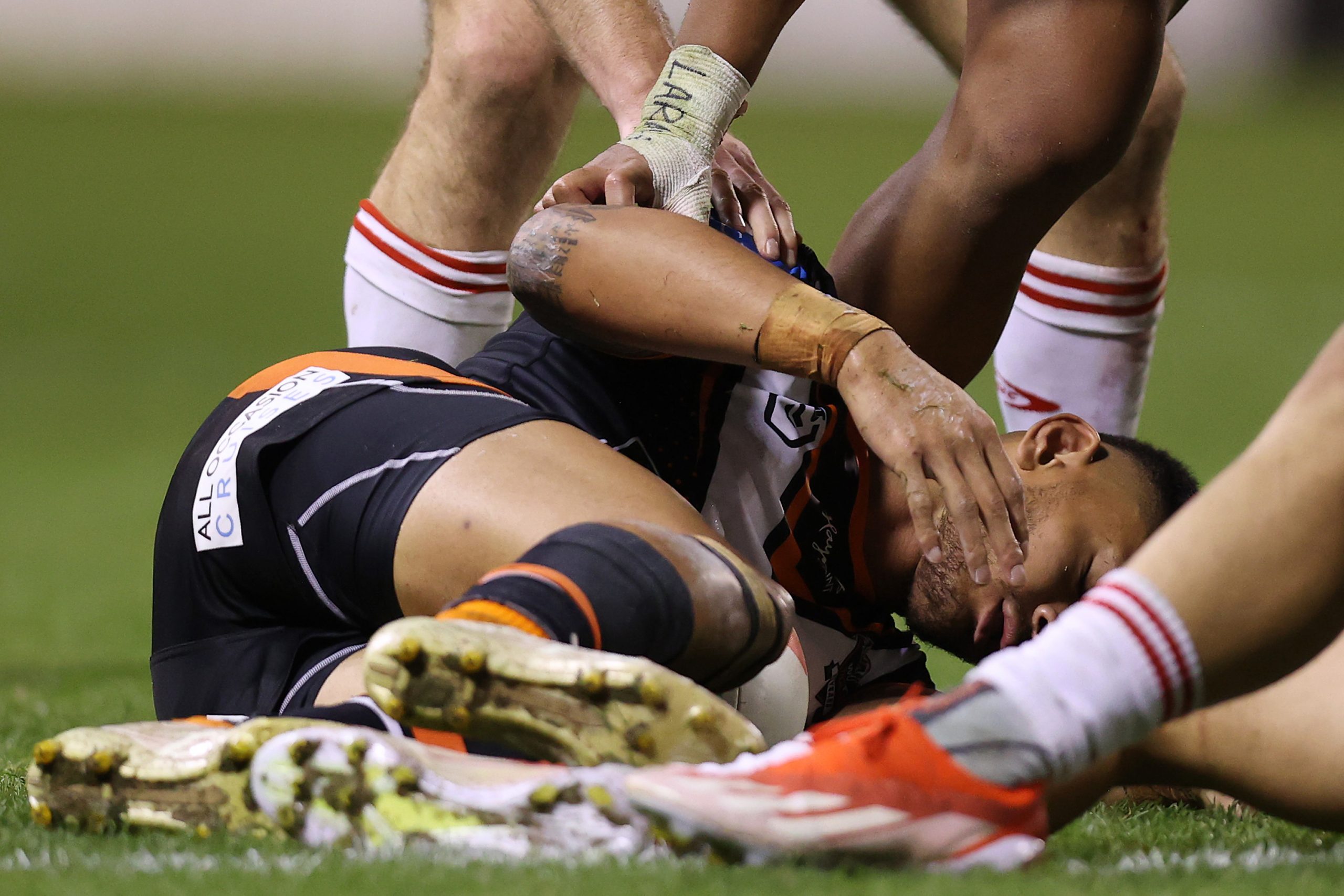 Solomon Alaimalo of the Wests Tigers is injured after a tackle with Zac Lomax of the Dragons during the round 14 NRL match between St George Illawarra Dragons and Wests Tigers at WIN Stadium on June 07, 2024, in Wollongong, Australia. (Photo by Jason McCawley/Getty Images)