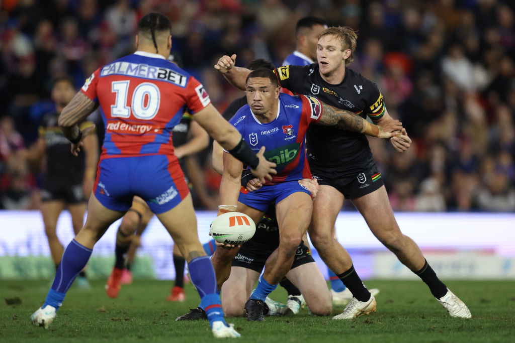 Tyson Frizell of the Knights off loads the ball.