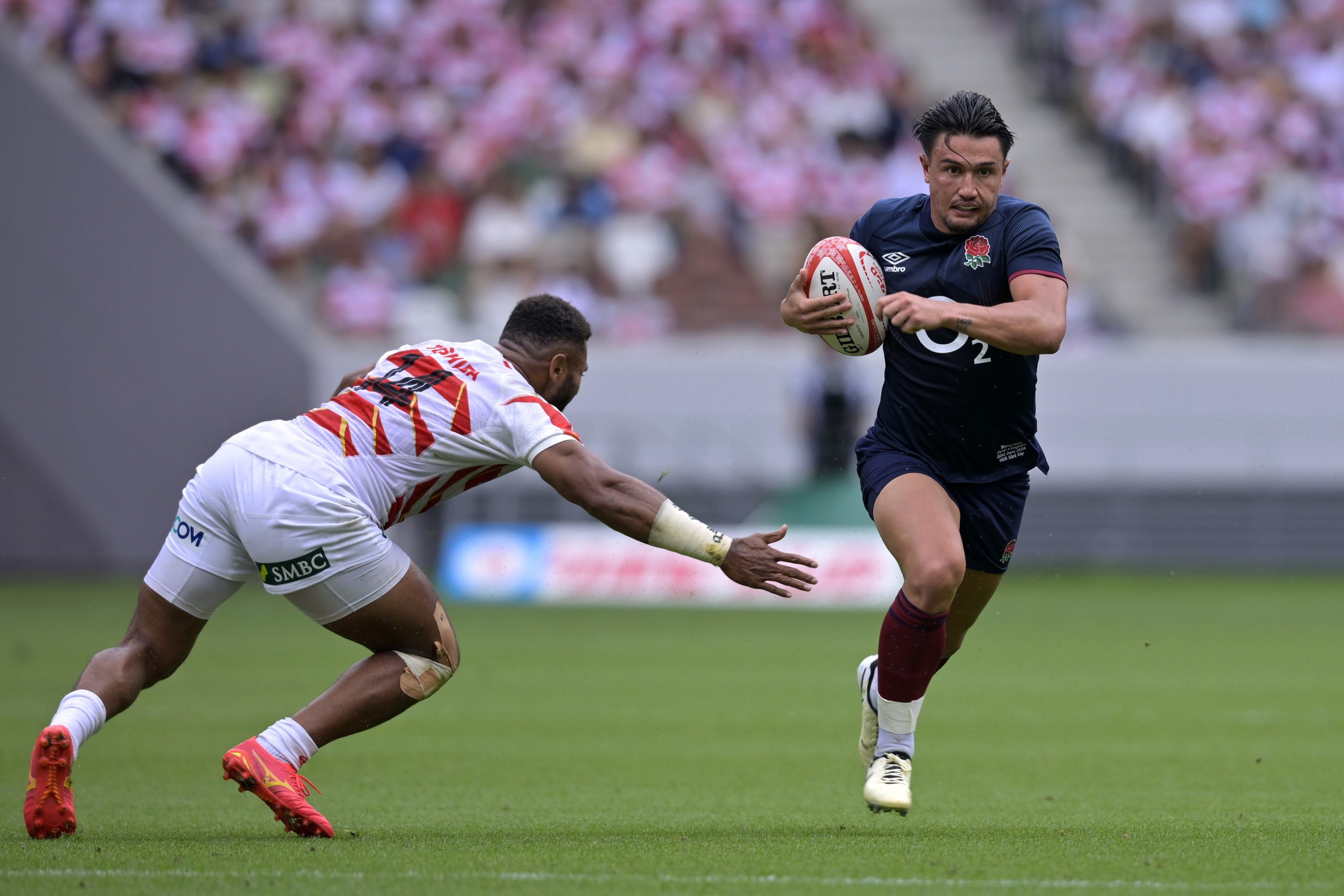 Marcus Smith of England goes past Jone Naikabula to make a break.