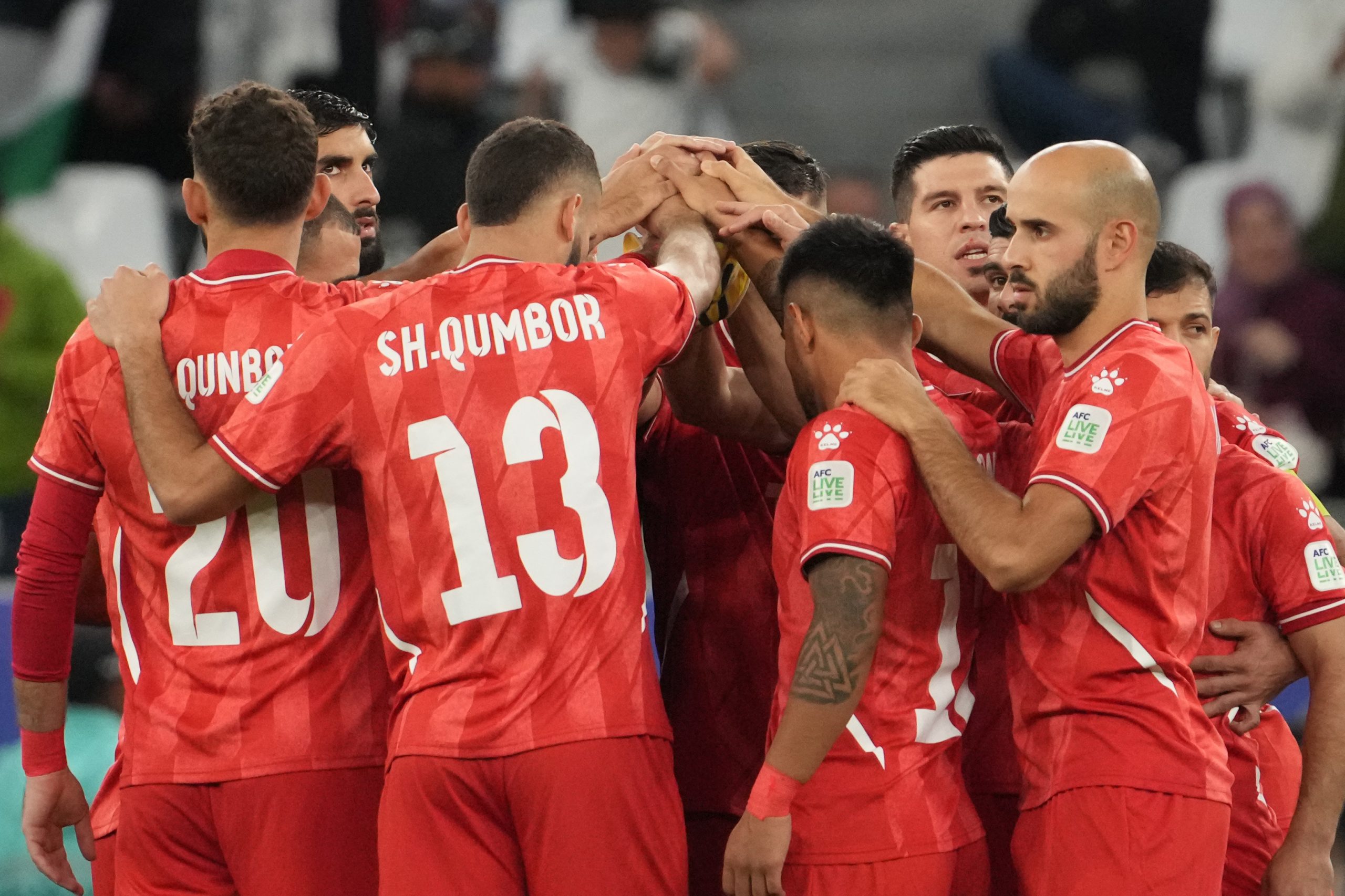 Players of Palestine make the hddle during the AFC Asian Cup Group C match between Iran and Palestine at Education City Stadium on January 14, 2024 in Al Rayyan, Qatar. (Photo by Masashi Hara/Getty Images)