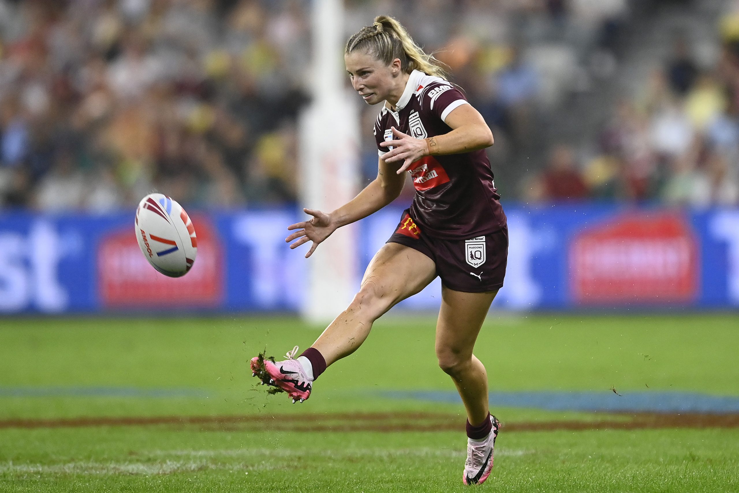 Tarryn Aiken of the Maroons kicks the ball.