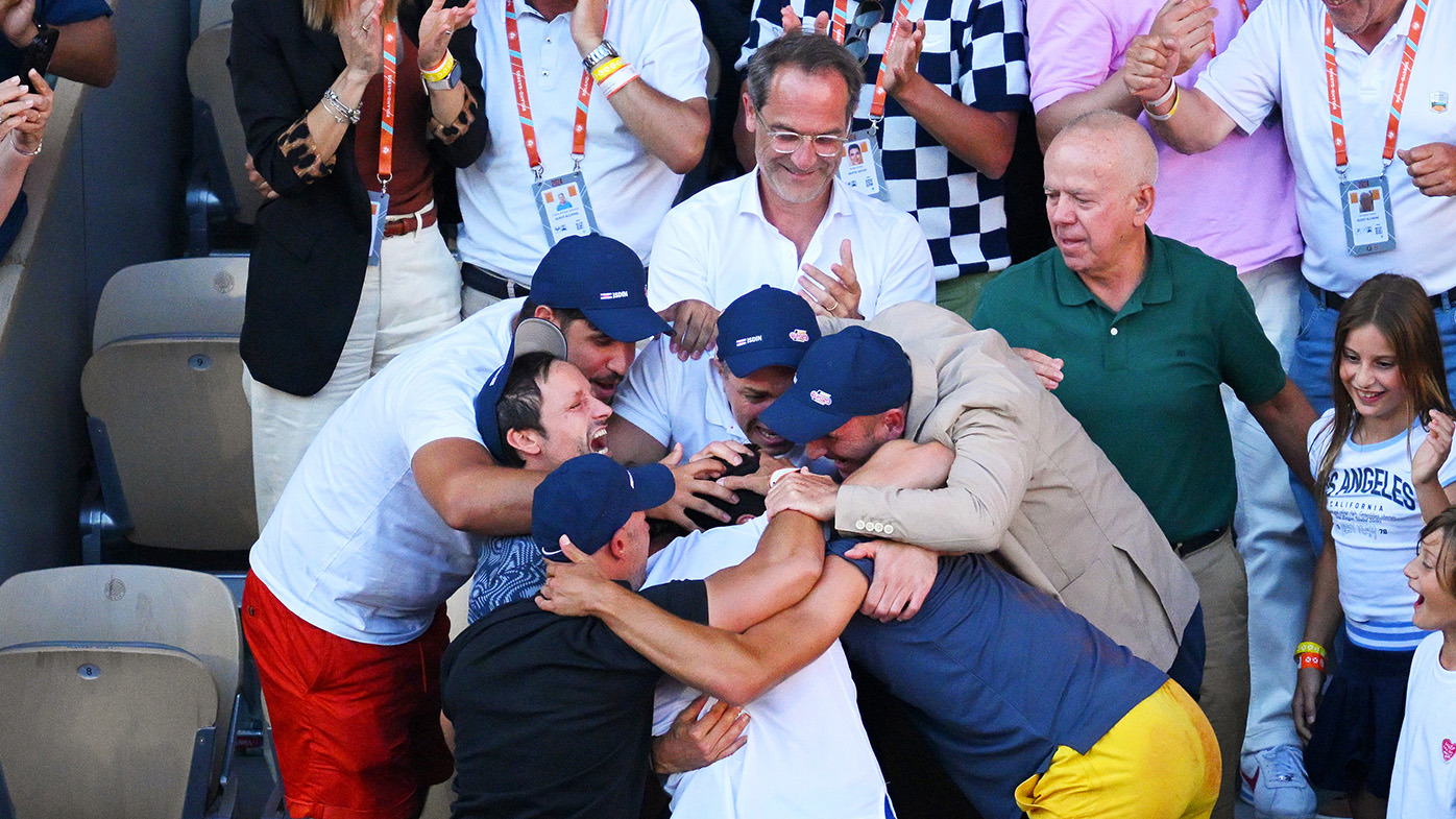 Carlos Alcaraz celebrating winning the French Open with his family and team.