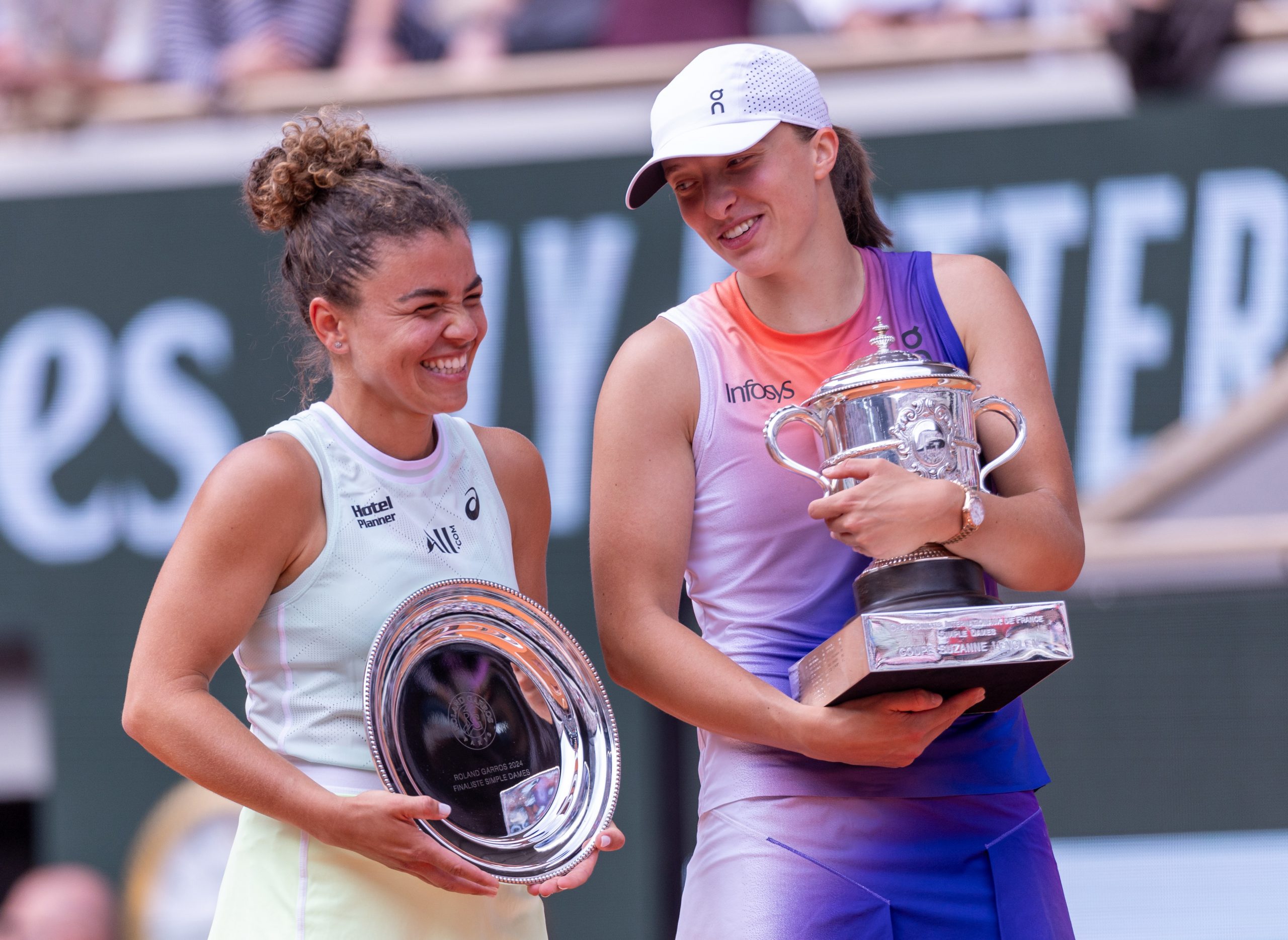 Jasmine Paolini of Italy and Iga Swiatek of Poland react with their runners-up and winners trophies after the Women's Singles Final match on Day 14 of the 2024 French Open at Roland Garros on June 08, 2024 in Paris, France. (Photo by Tnani Badreddine/DeFodi Images via Getty Images)