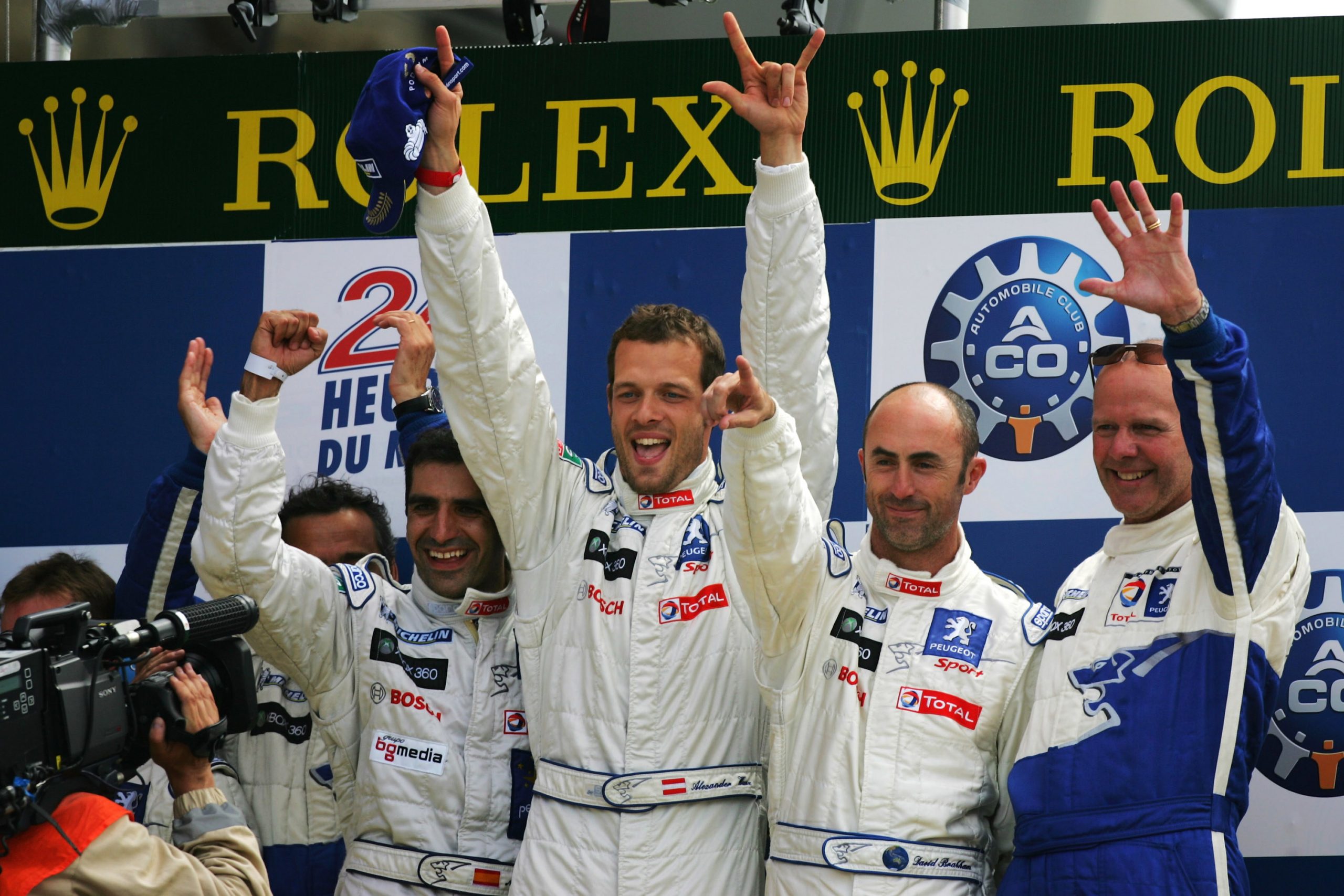 Peugeot drivers Marc Gene of Spain, Alex Wurz of Austria, David Brabham of Australia and Olivier Quesnel director of Peugeot Sport celebrate winning the 77th running of the 24 Hours of Le Mans.