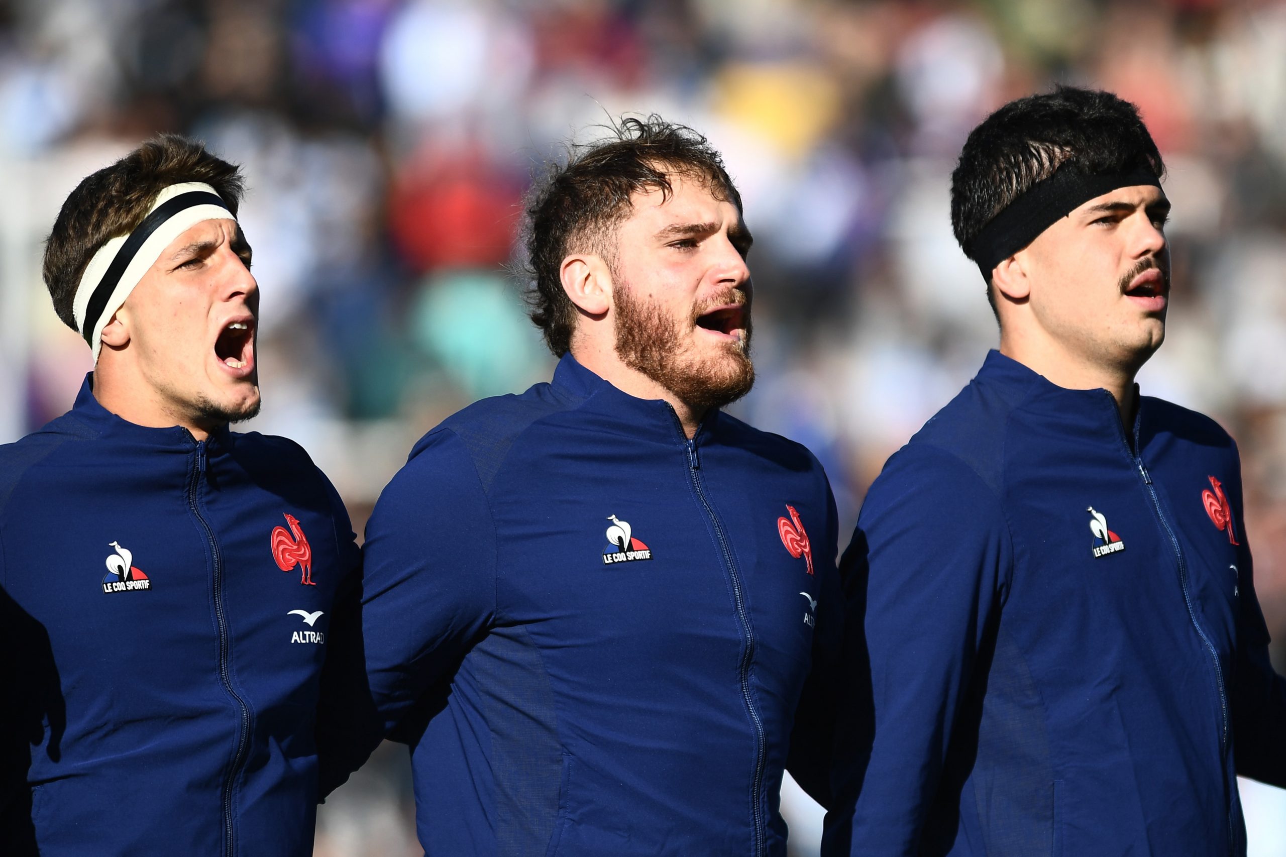 Oscar Jegou, Lenni Nouchi, Hugo Auradou of France sing the national anthem.