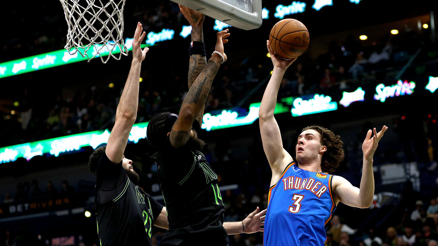 Thunder star Josh Giddey attempts to shoot over two defenders in Oklahoma City's playoffs win over the New Orleans Pelicans.