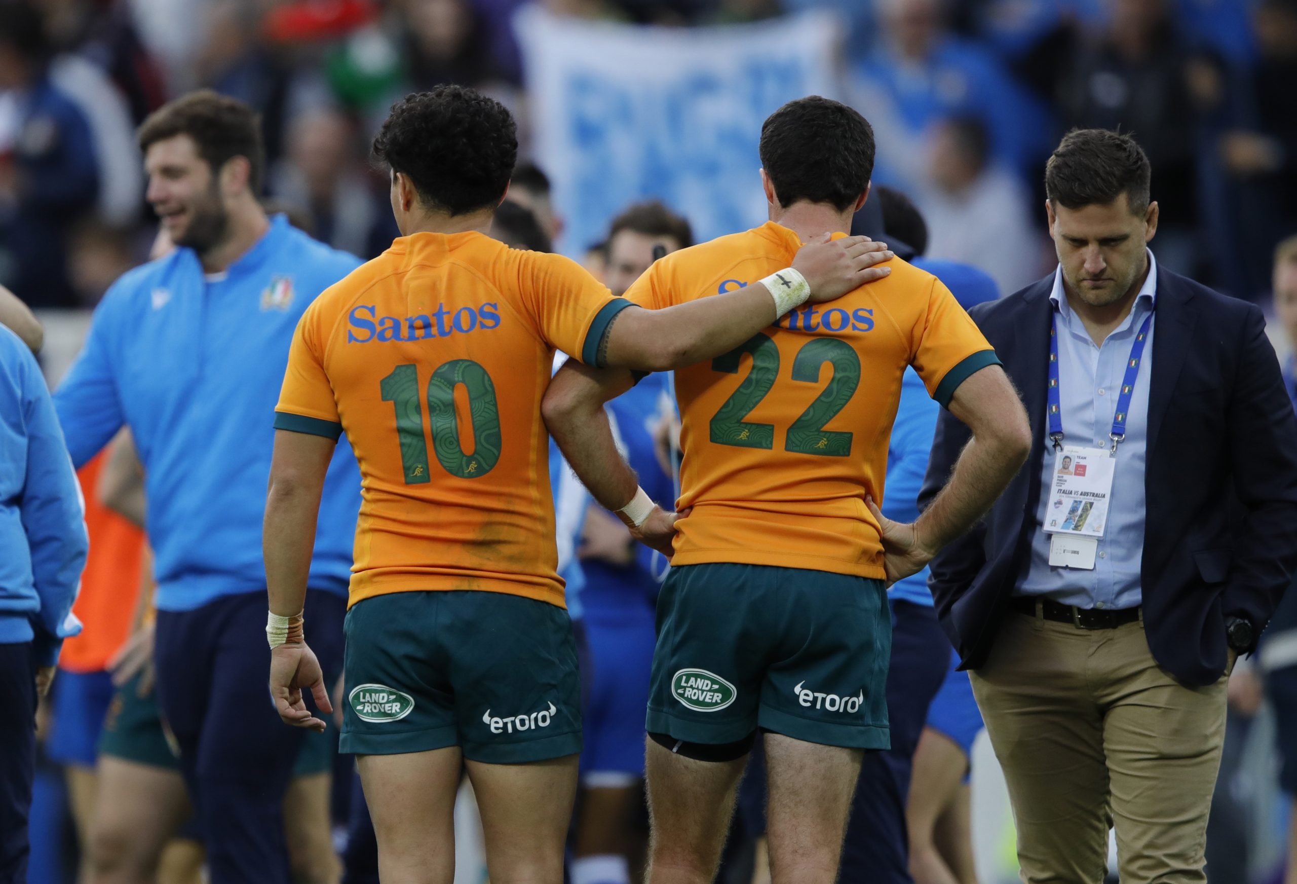 Noah Lolesio of Australia consoles Ben Donaldson after losing to Italy in 2022.