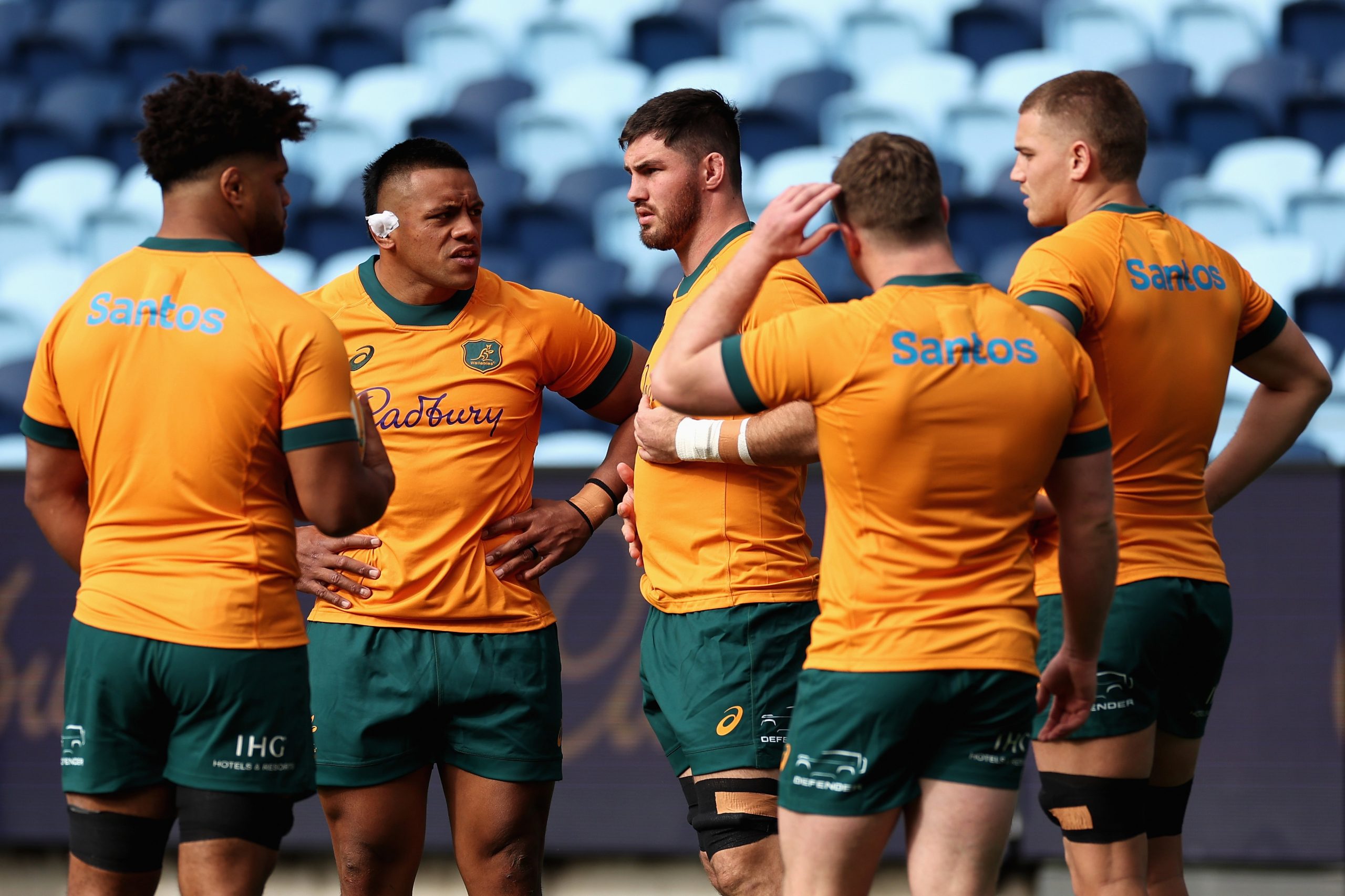 Wallabies captain Liam Wright talks to Allan Alaalatoa and teammates at Allianz Stadium.