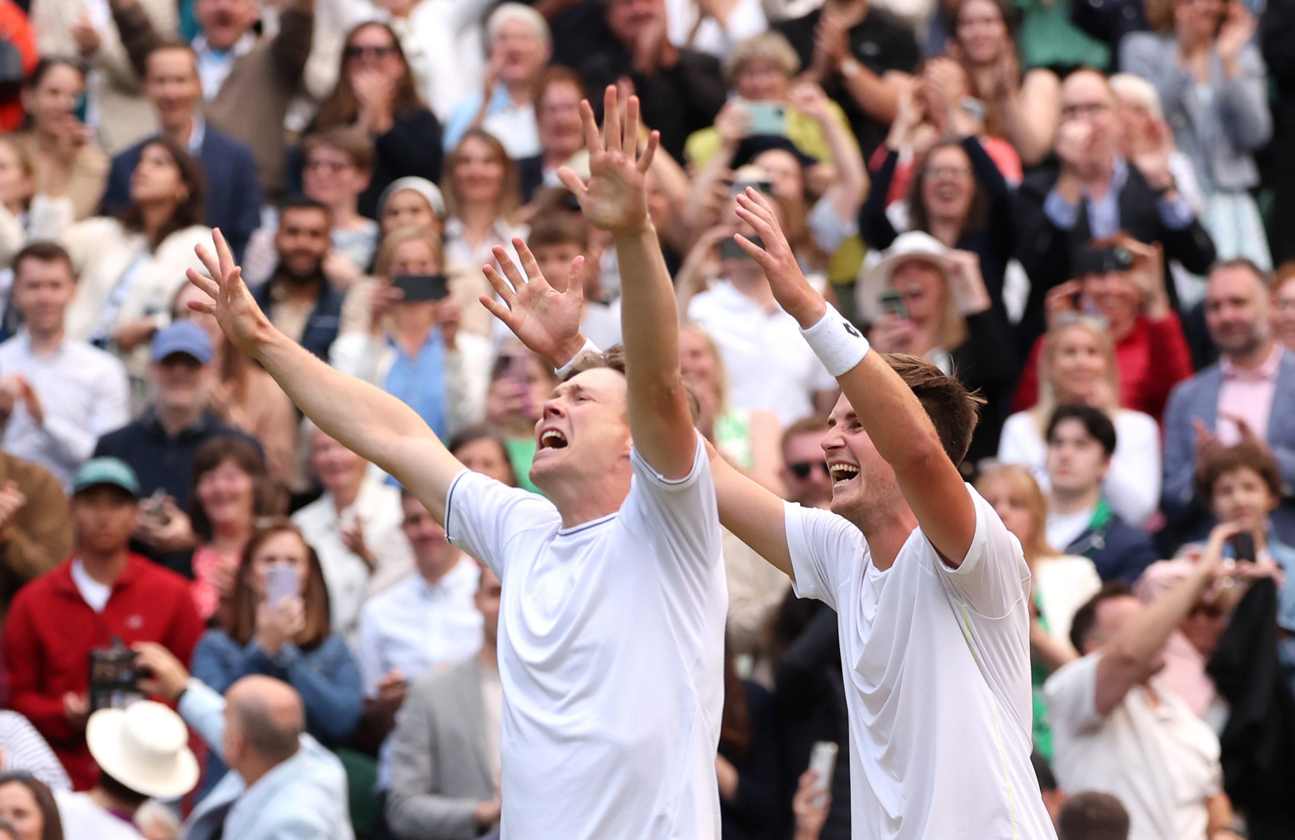 Harri Heliovaara of Finland and Henry Patten of Great Britain celebrate winning Championship point against Max Purcell and Jordan Thompson of Australia in the Gentlemen's Doubles Final during day thirteen of The Championships Wimbledon 2024 at All England Lawn Tennis and Croquet Club on July 13, 2024 in London, England. (Photo by Julian Finney/Getty Images)