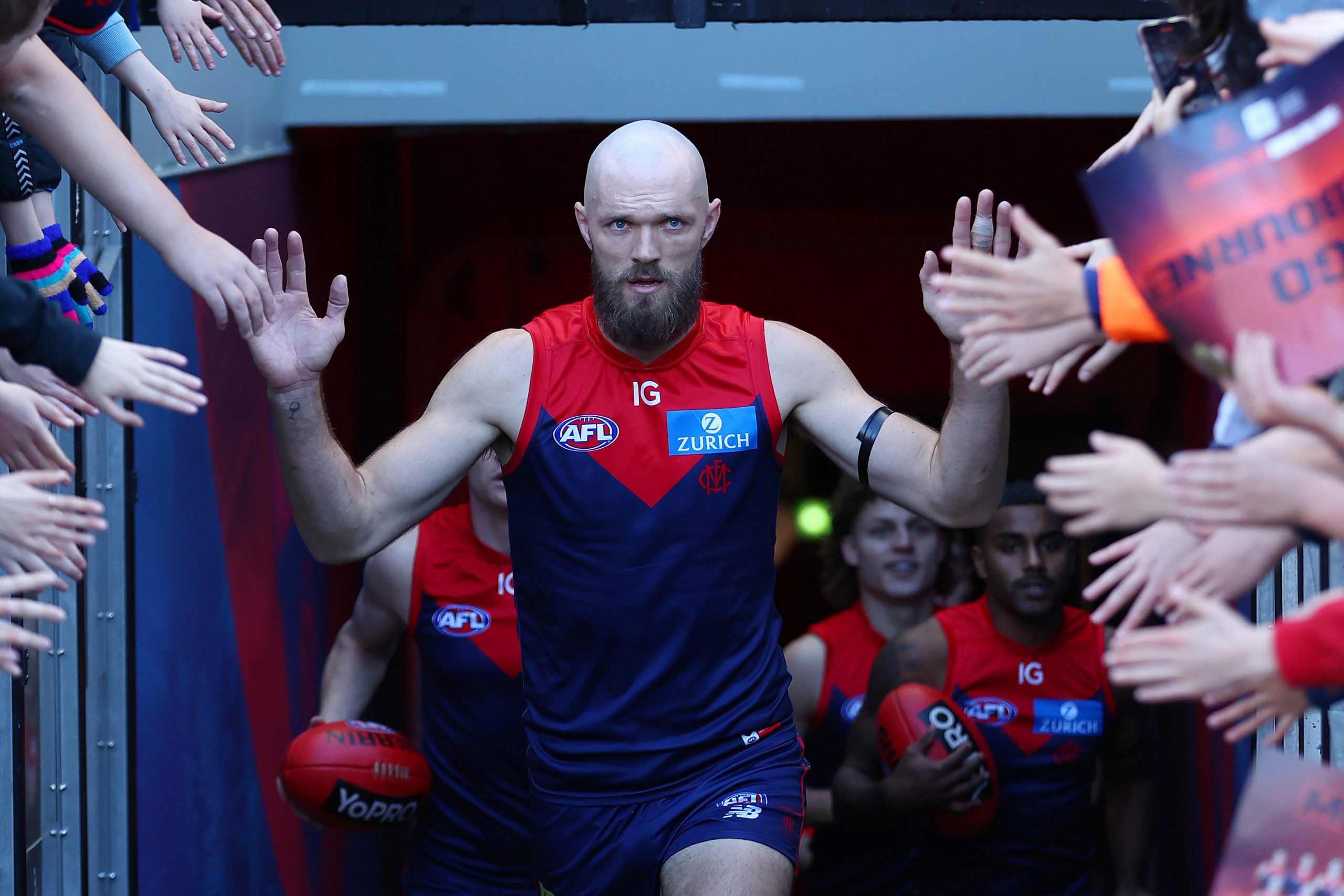 Max Gawn of the Demons leads the team out for their match against West Coast.