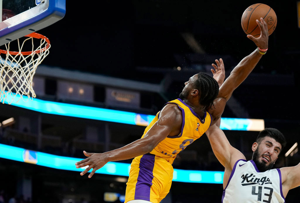 Bronny James Jr. goes up to slam dunk and gets fouled by Fardaws Aimaq #43 of the Sacramento Kings.