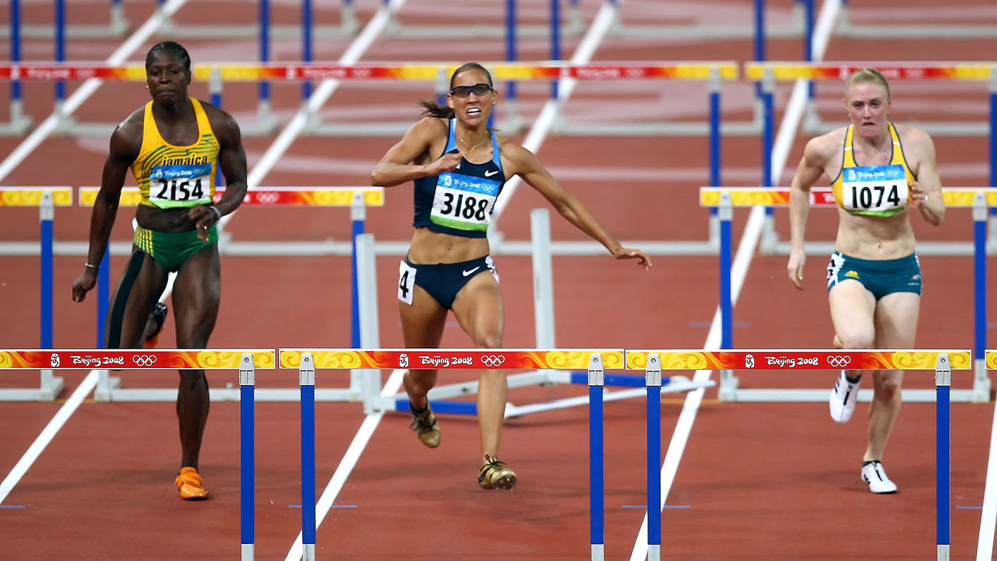 Lolo Jones (centre) trips over the second-last hurdle in Beijing.