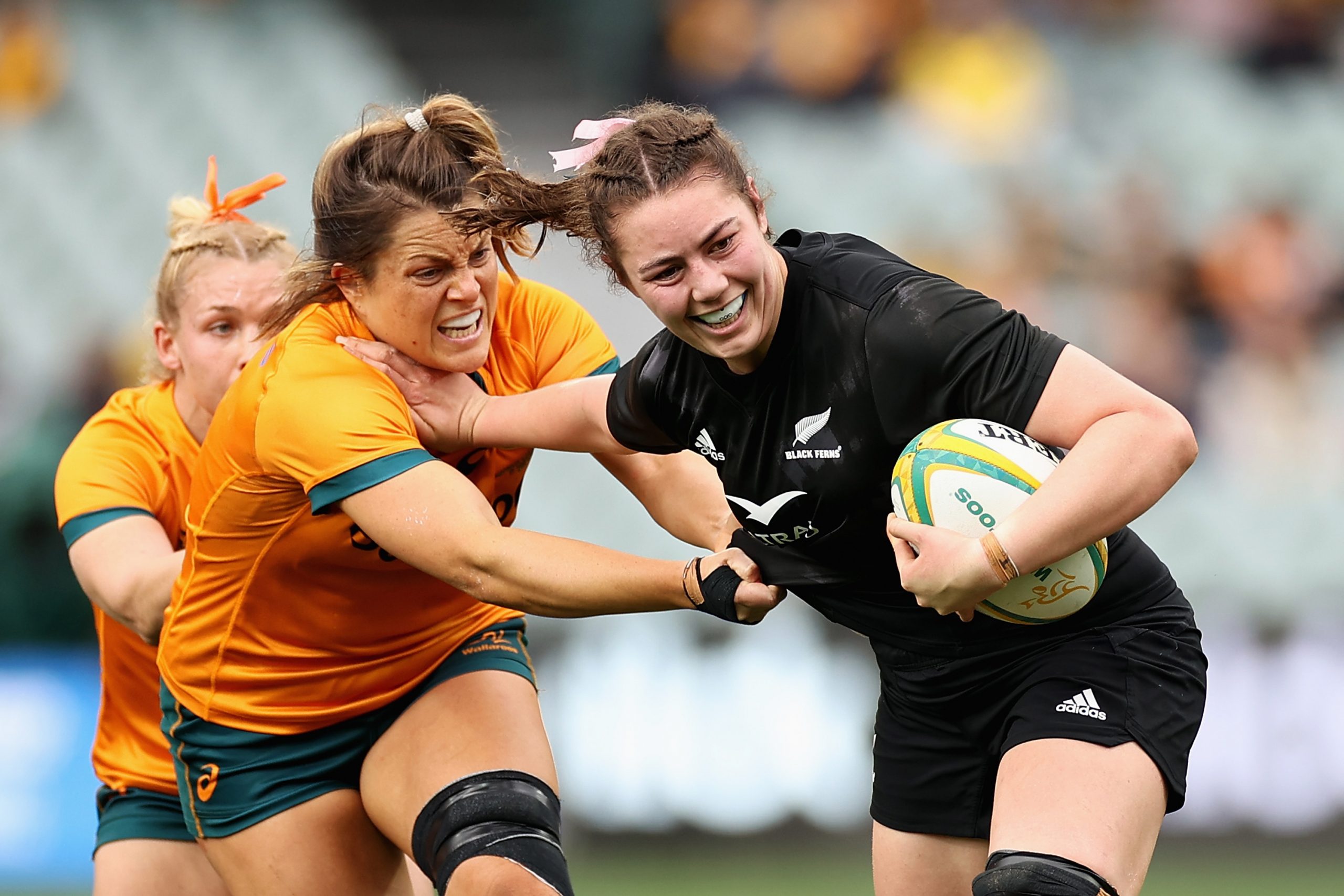 Maiakawanakaulani Roos of the Black Ferns fends Grace Hamilton of the Wallaroos.