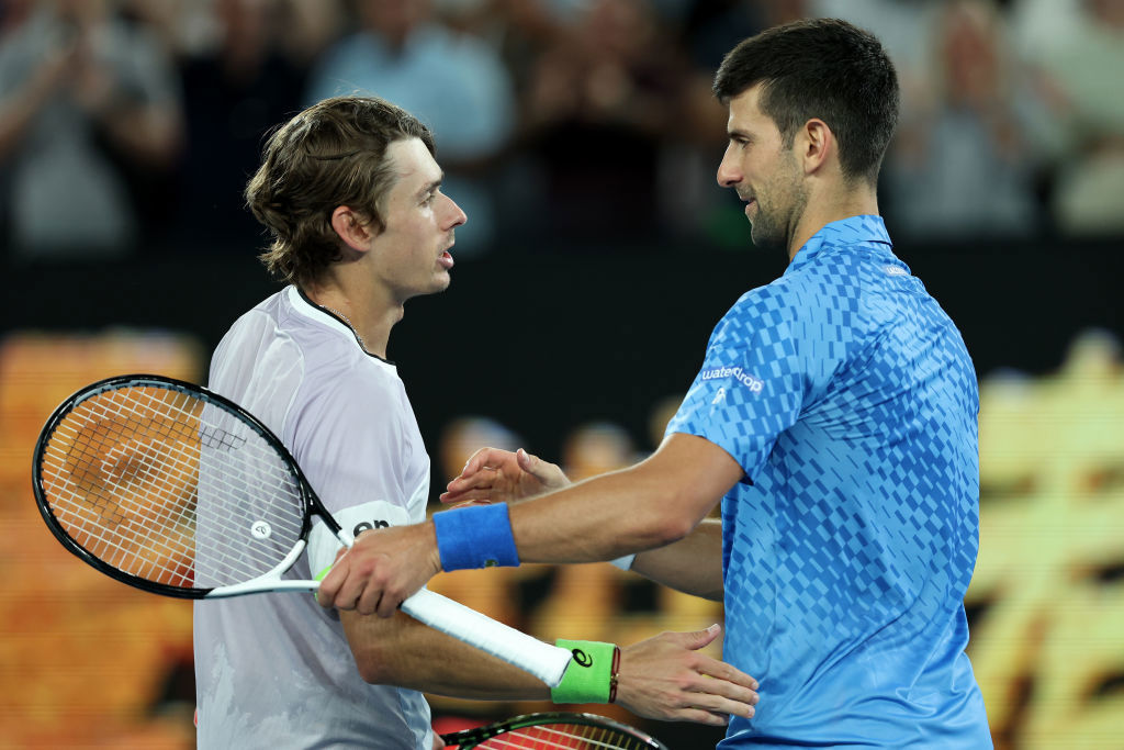 Alex de Minaur and Novak Djokovic embrace at the net. Australian Open.