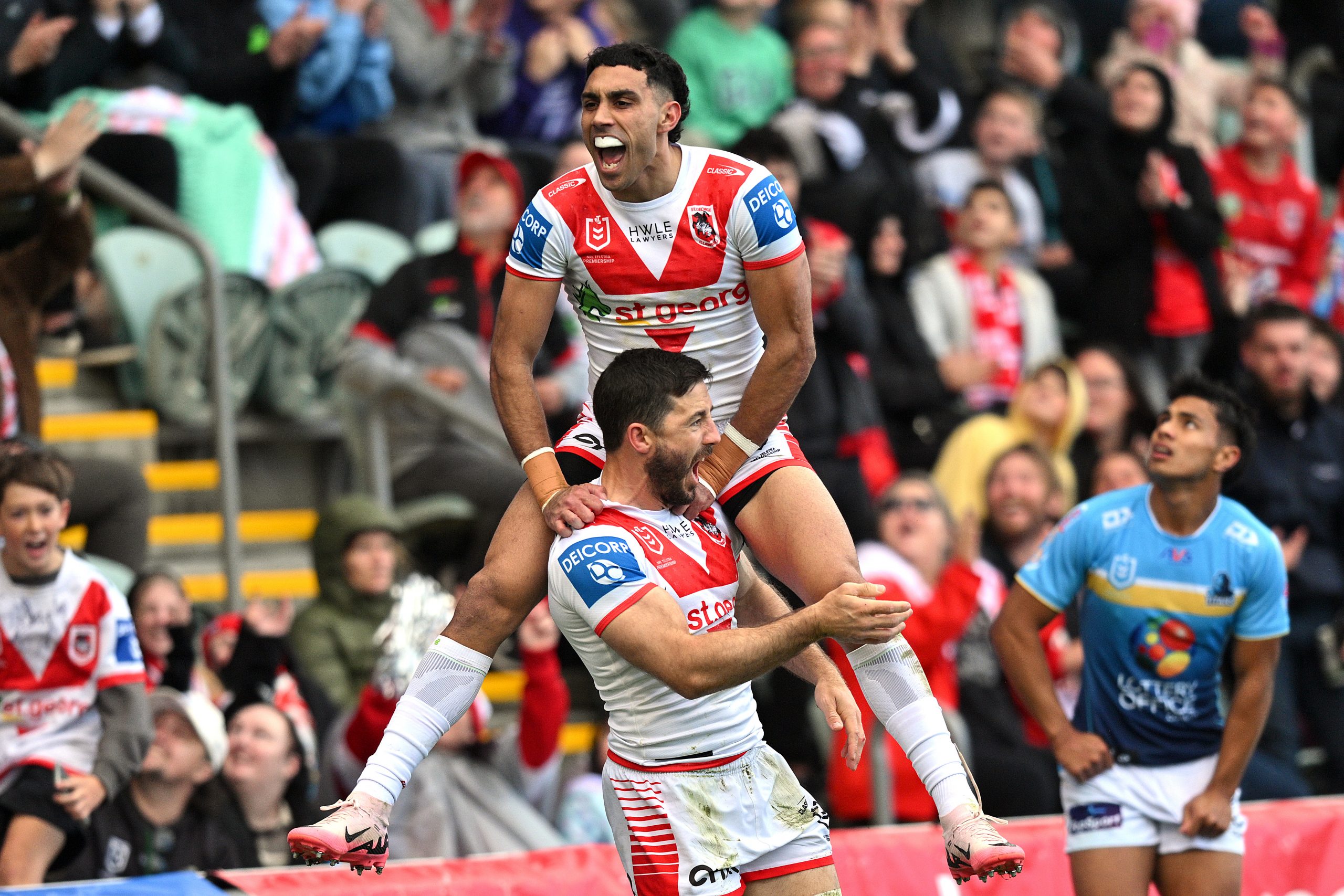 Tyrell Sloan celebrates scoring a try with Ben Hunt.