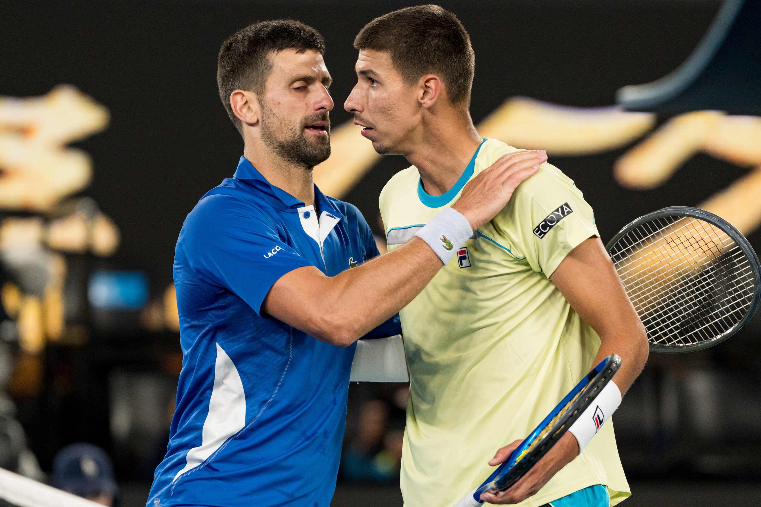 Novak Djokovic (L) of Serbia embraces Alexei Popyrin (R) of Australia after winning match point in his round two singles match during day four of the 2024 Australian Open at Melbourne Park on January 17, 2024 in Melbourne, Australia. (Photo by Andy Cheung/Getty Images)