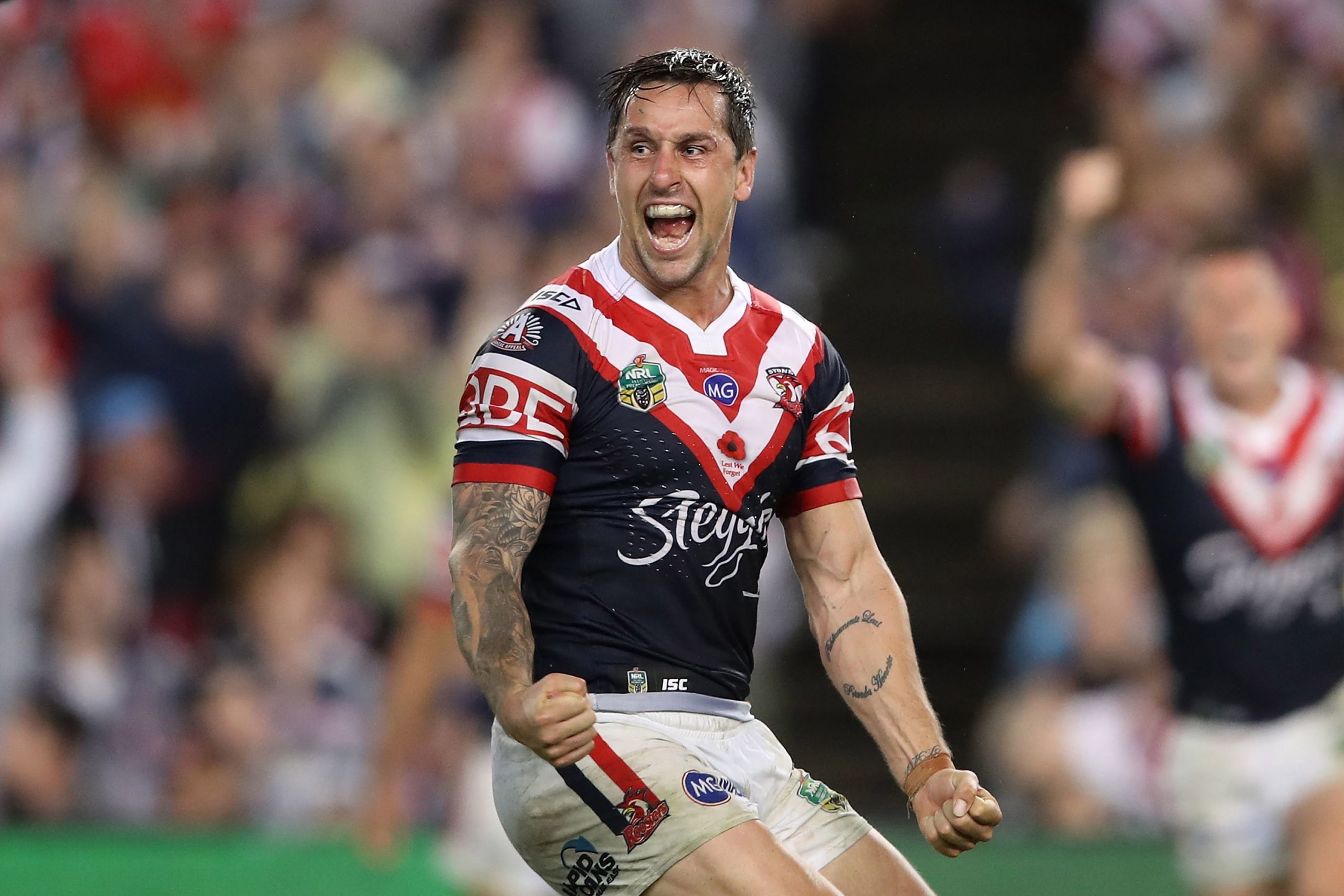 Mitchell Pearce of the Roosters celebrates kicking a field goal to claim golden point victory during a clash against the Dragons in 2017. 