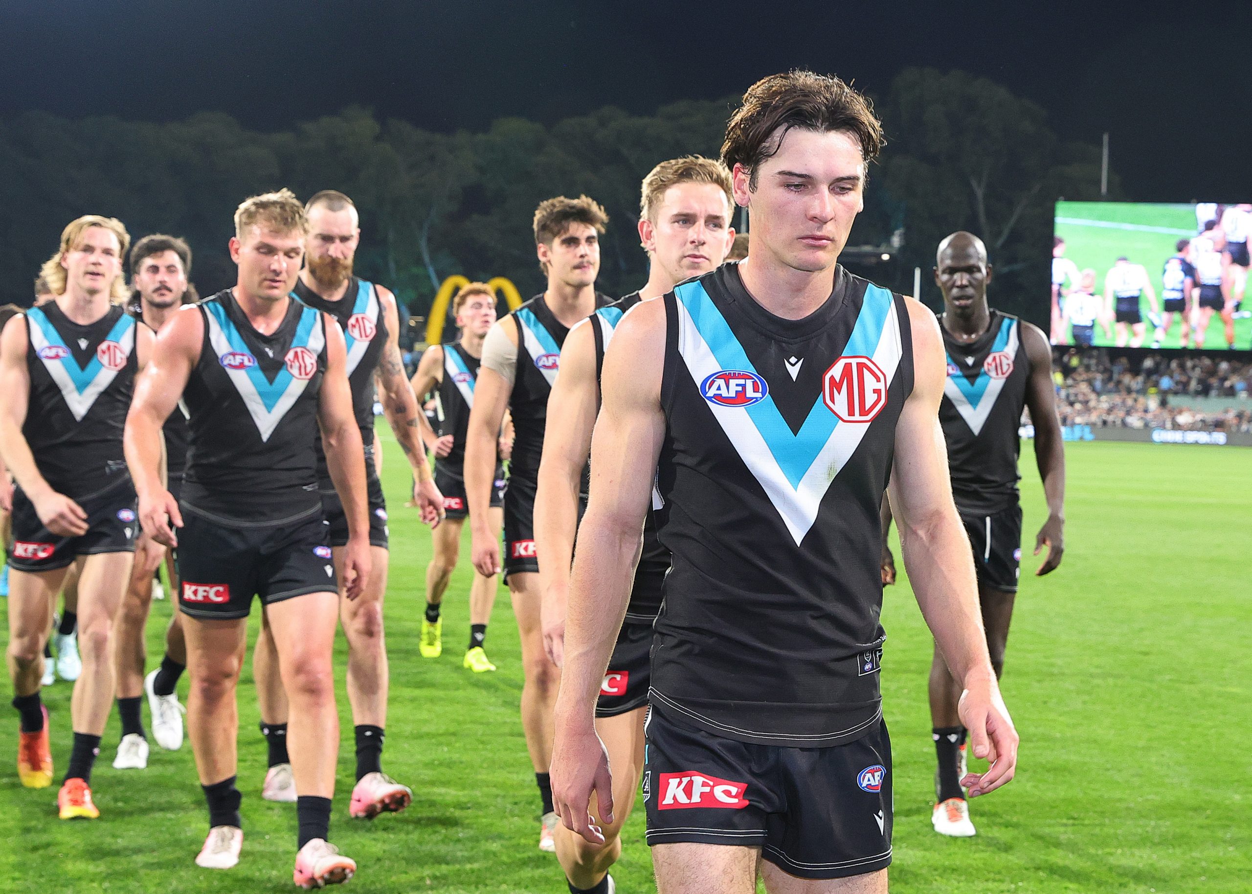 Connor Rozee of the Power leads his team off after their loss to Geelong.