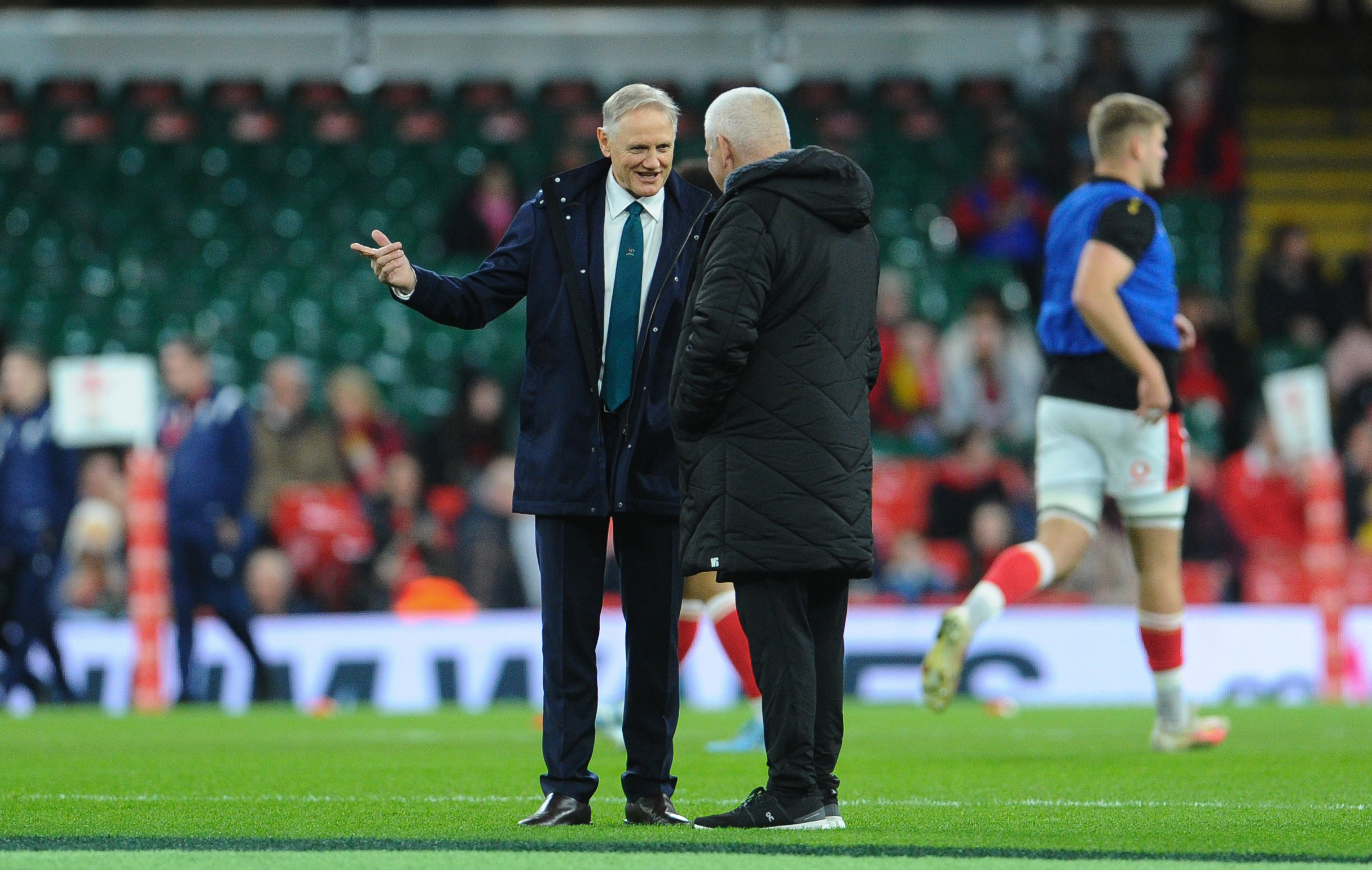 Australia coach Joe Schmidt chats to Wales coach Warren Gatland.