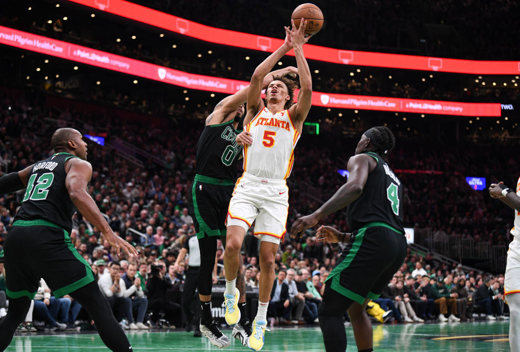 Dyson Daniels of the Atlanta Hawks battles for against Jayson Tatum of the Boston Celtics.