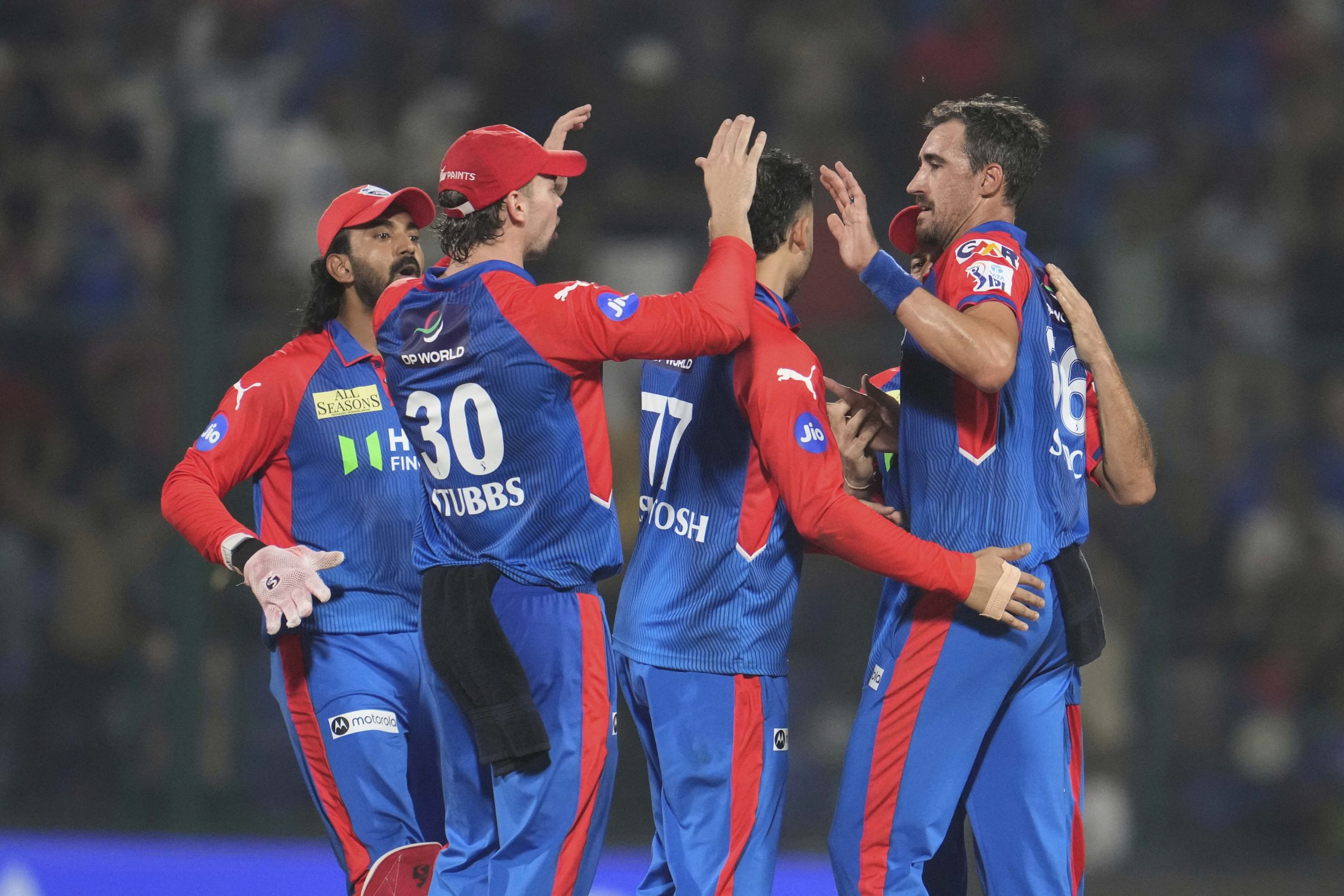 Delhi Capitals' Mitchell Starc celebrates with teammates.
