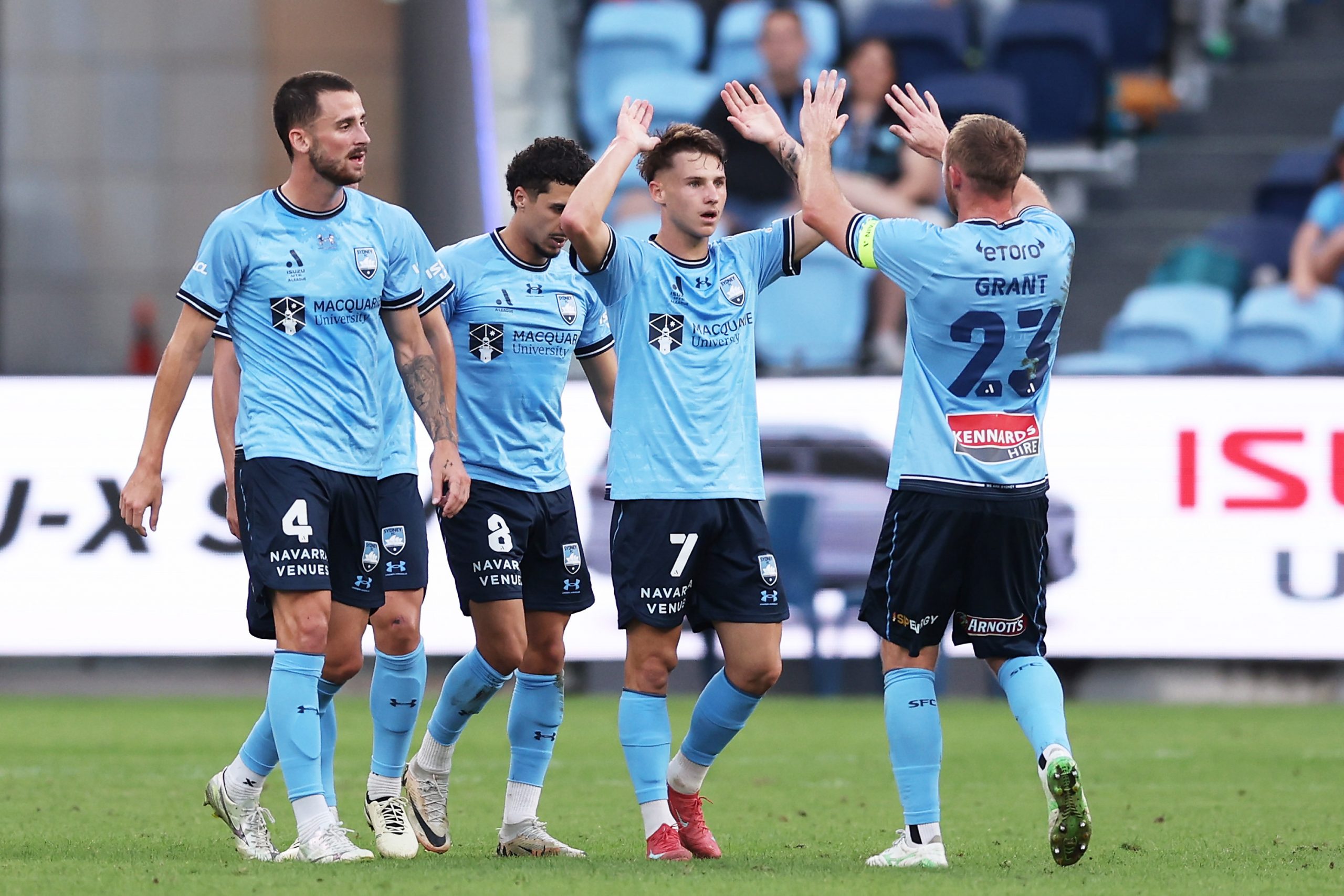 Adrian Segecic celebrates with his Sydney FC teammates after scoring a goal.