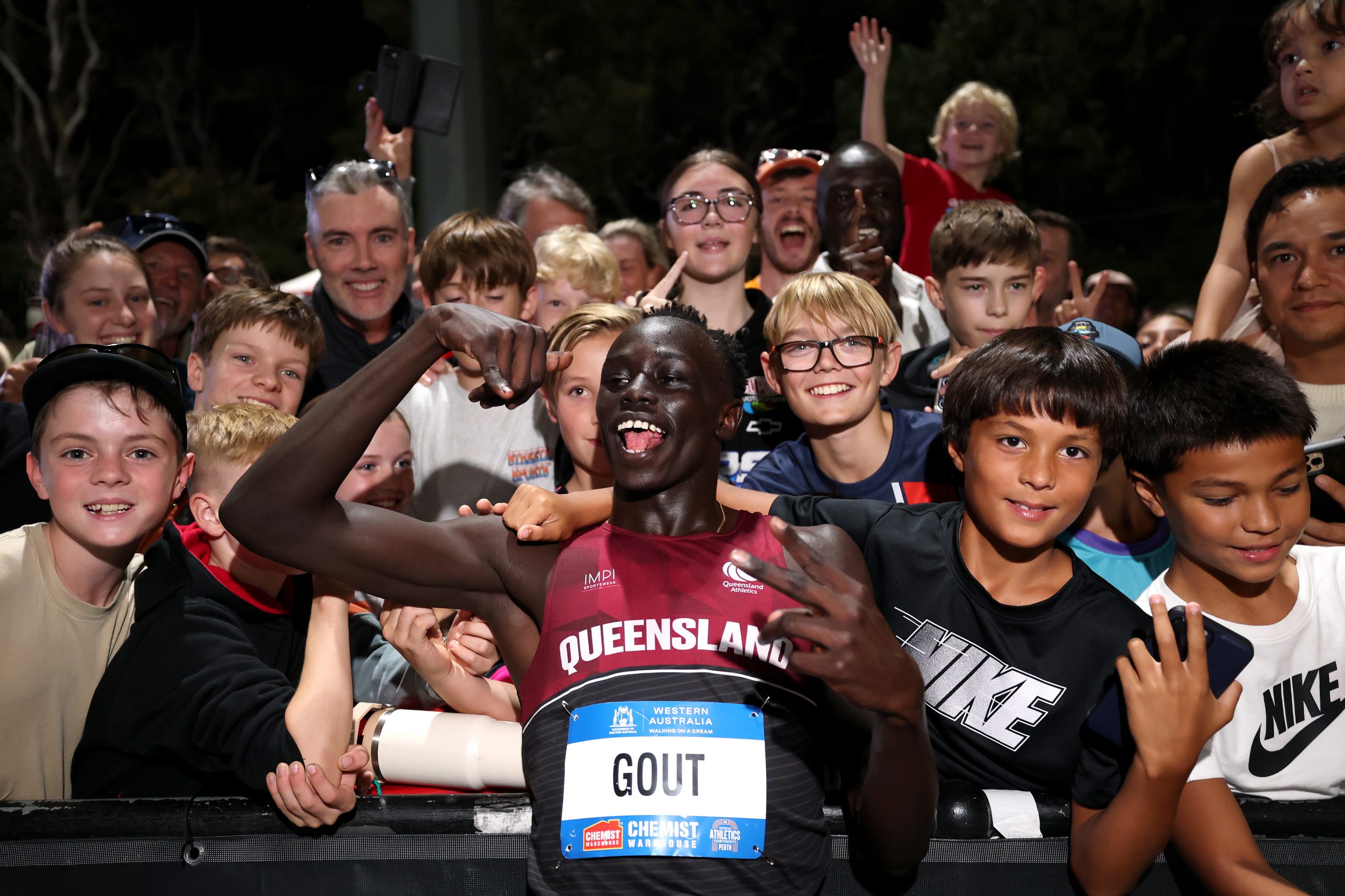 Gout Gout laps up the enormous crowd support after the final at WA Athletics Stadium.