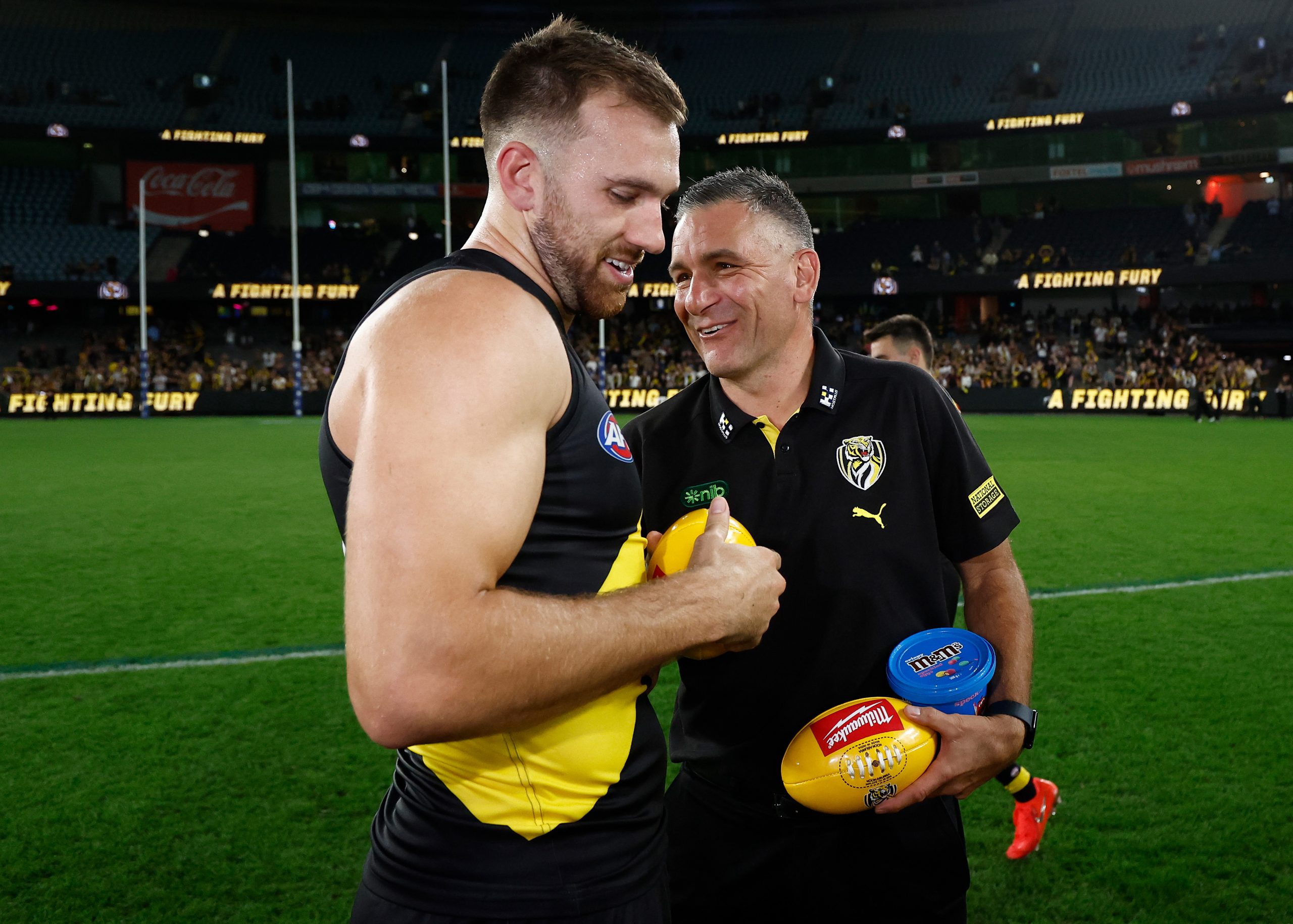 MELBOURNE, AUSTRALIA - APRIL 19: Noah Balta of the Tigers and Adem Yze, Senior Coach of the Tigers celebrates during the 2025 AFL Round 06 match between the Richmond Tigers and the Gold Coast Suns at Marvel Stadium on April 19, 2025 in Melbourne, Australia. (Photo by Michael Willson/AFL Photos via Getty Images)