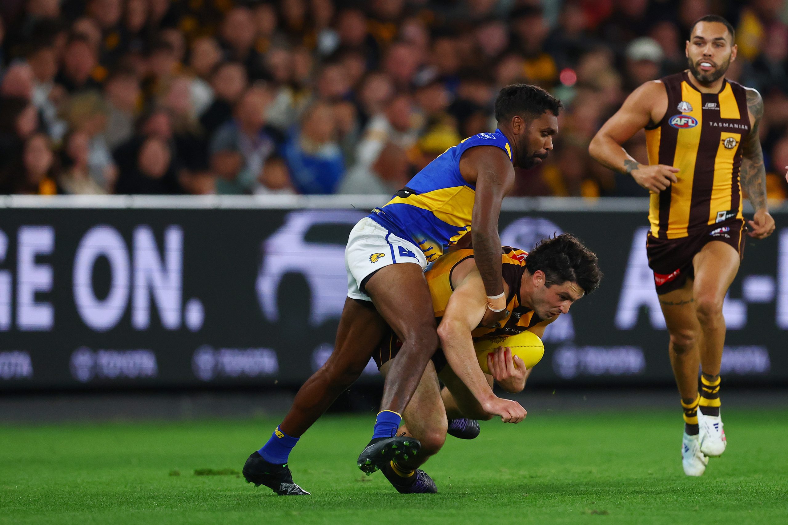 Liam Ryan of the Eagles and Tom Barrass of the Hawks compete for the ball.