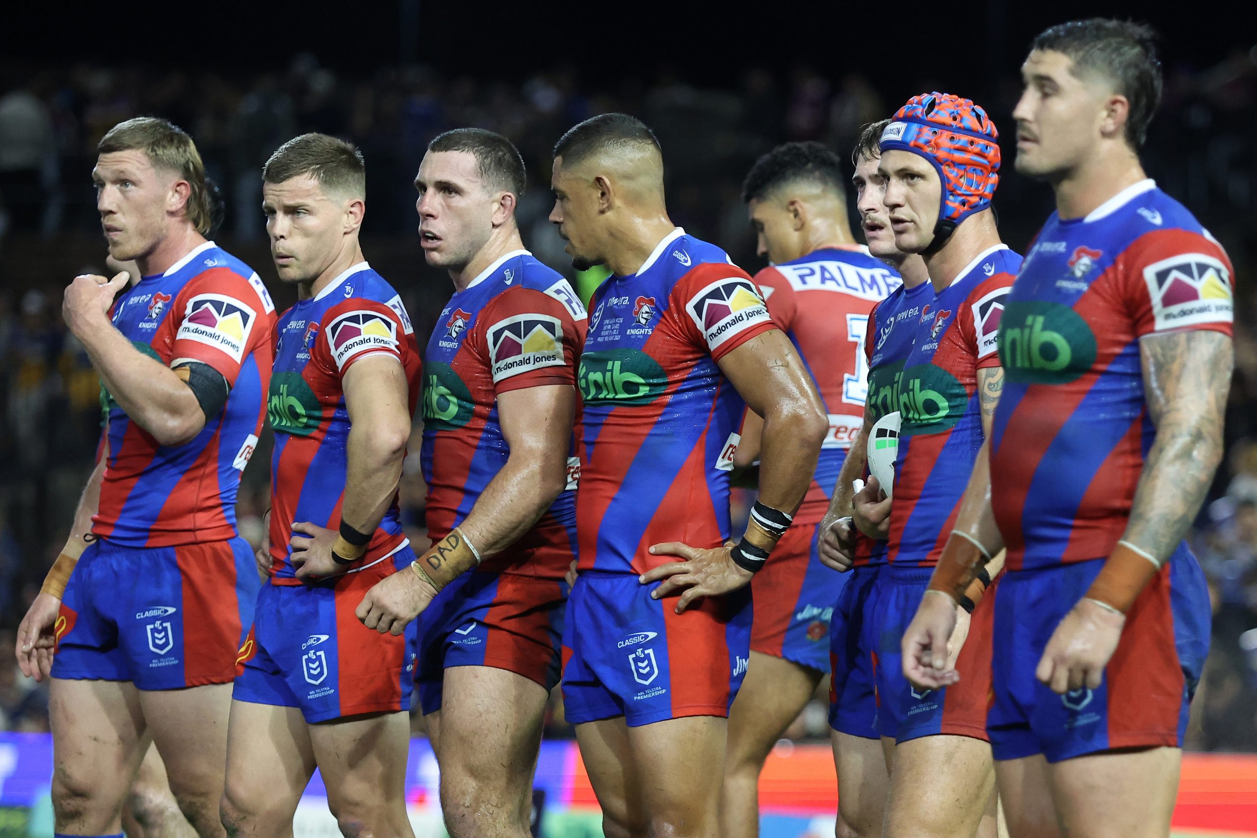 Knights players react to an Eels try.