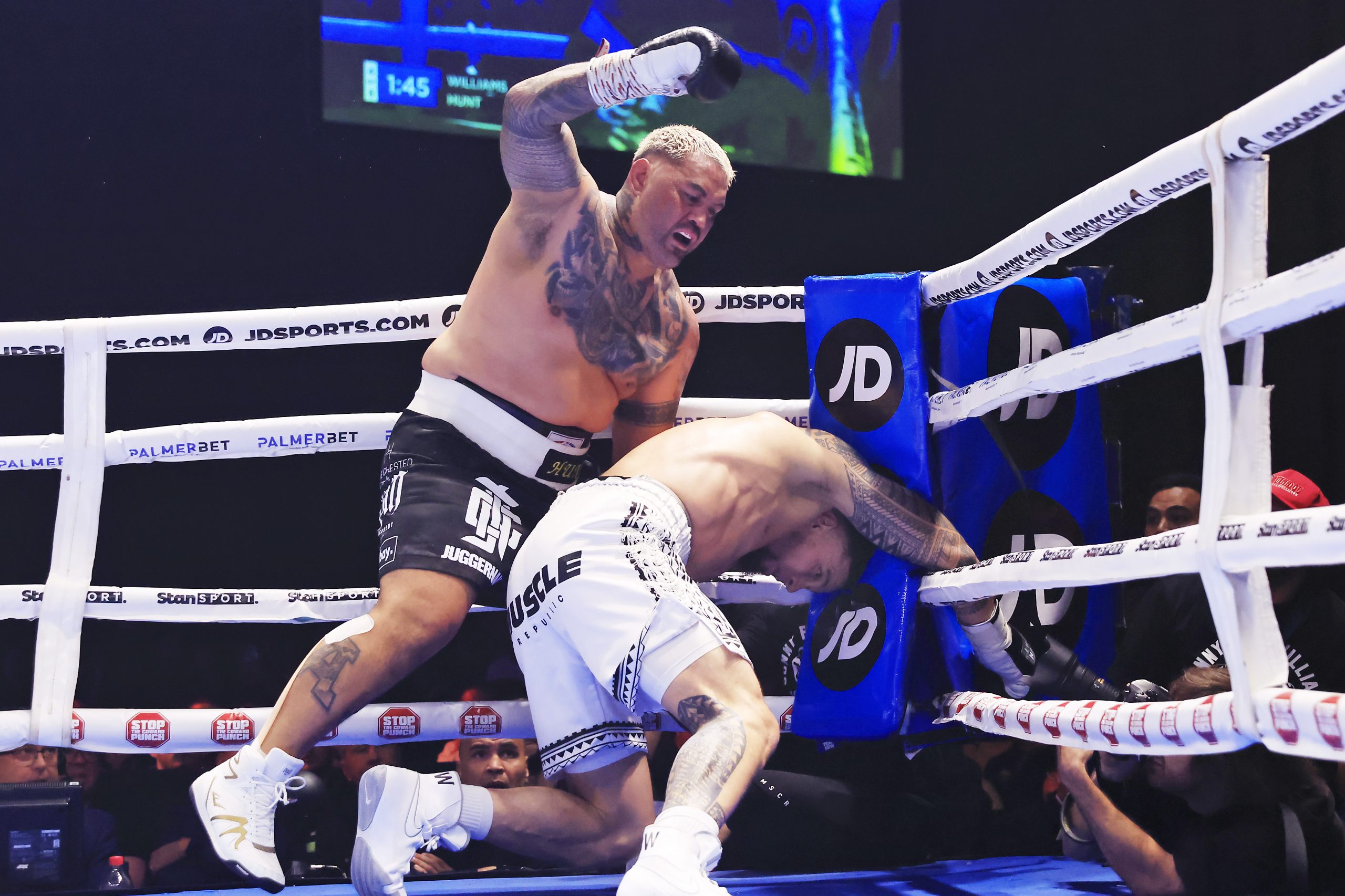 Mark Hunt throws a punch as Sonny Bill Williams goes down.