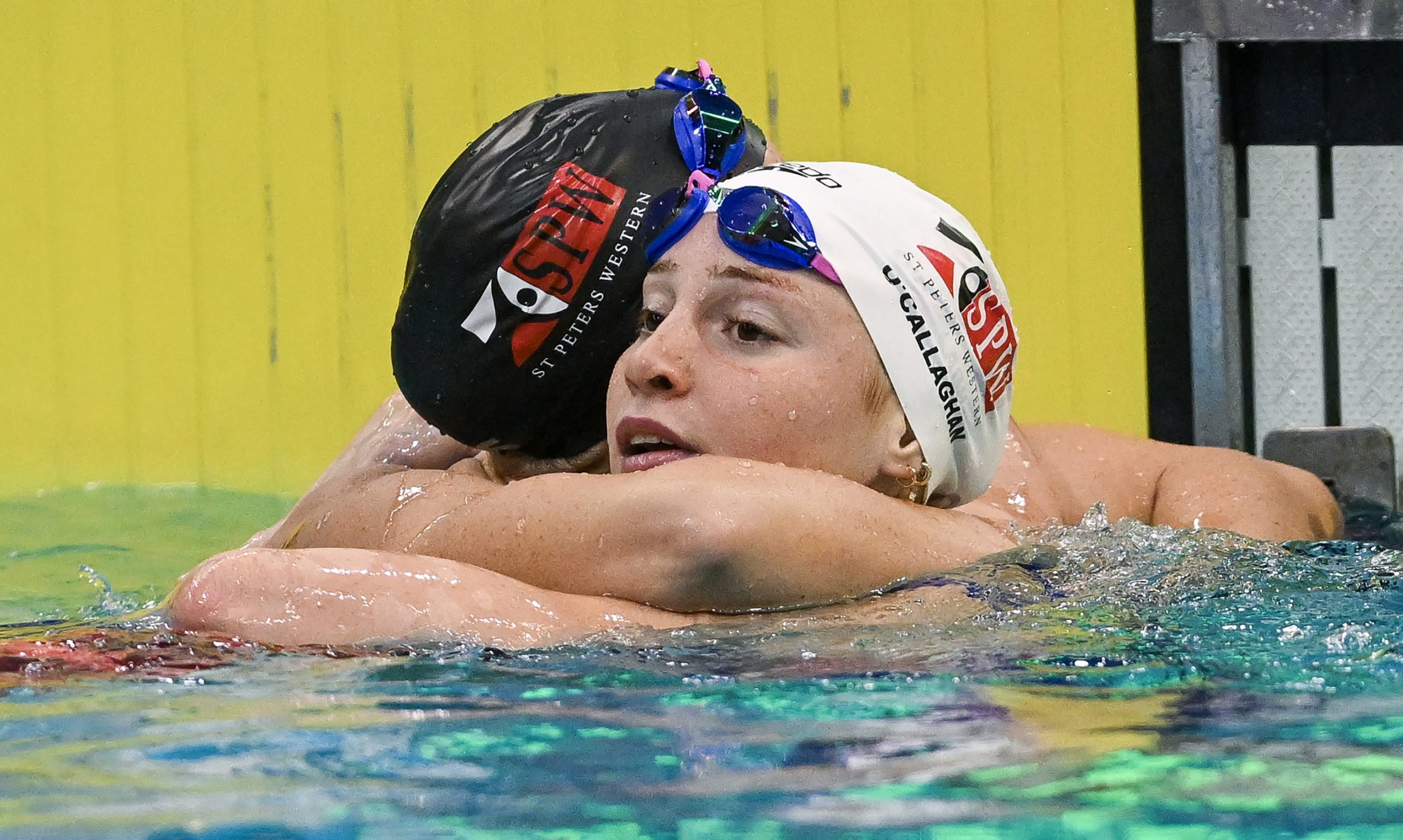 Mollie O'Callaghan and Lani Pallister embrace after the 200m freestyle final.