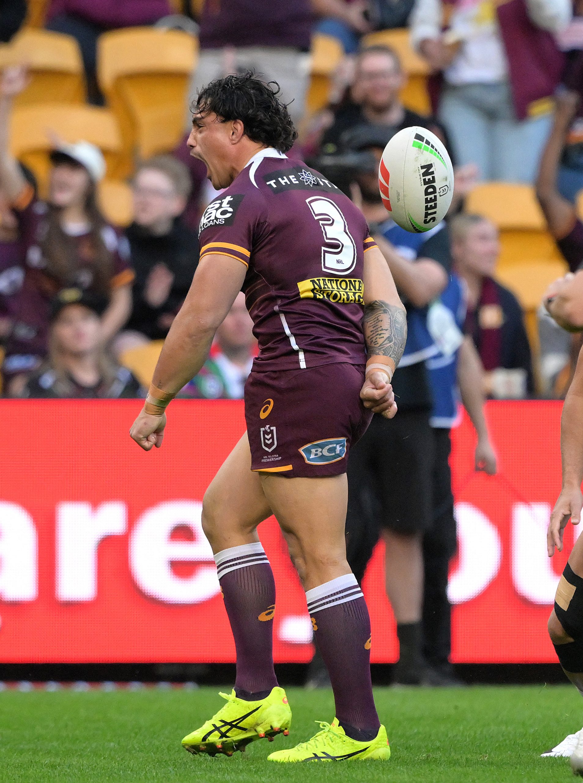 Kotoni Staggs celebrates after scoring a try during the round 17 NRL match between the Broncos and the Warriors.