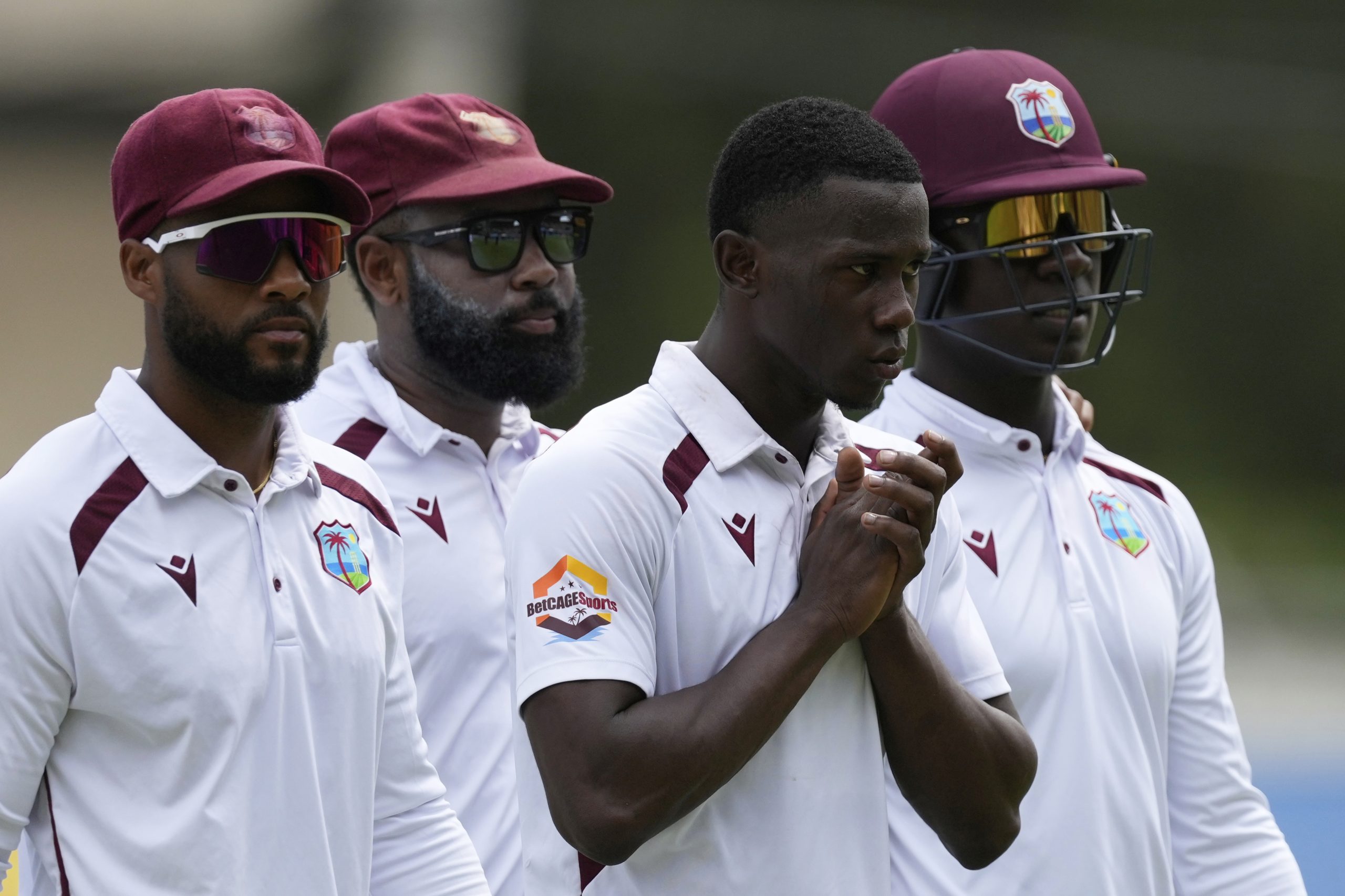 West Indies teammates walk to the pavilion after Australia's win.