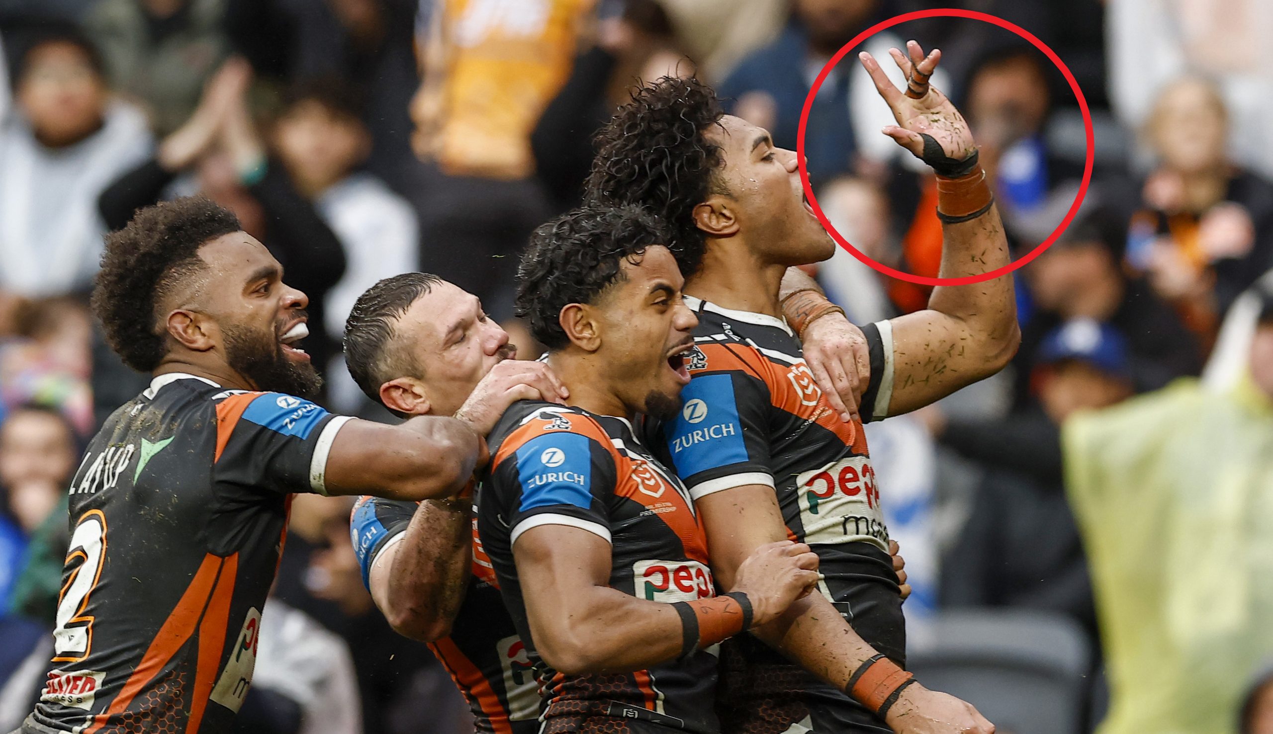 Wests Tigers player Samula Fainu gestures towards Bulldogs fans.