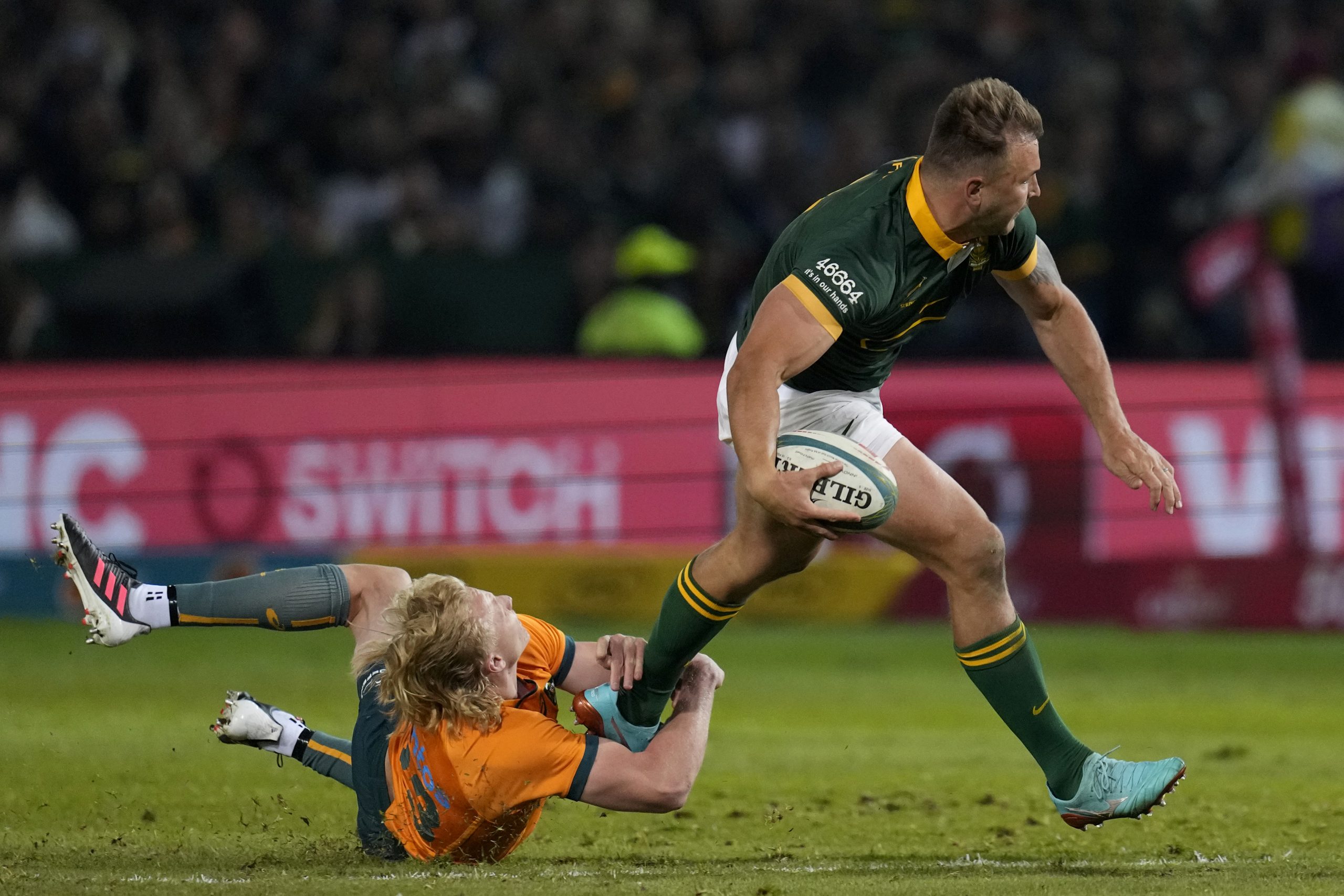 South Africa's Andre Esterhuizen is tackled by Australia's Carter Gordon.