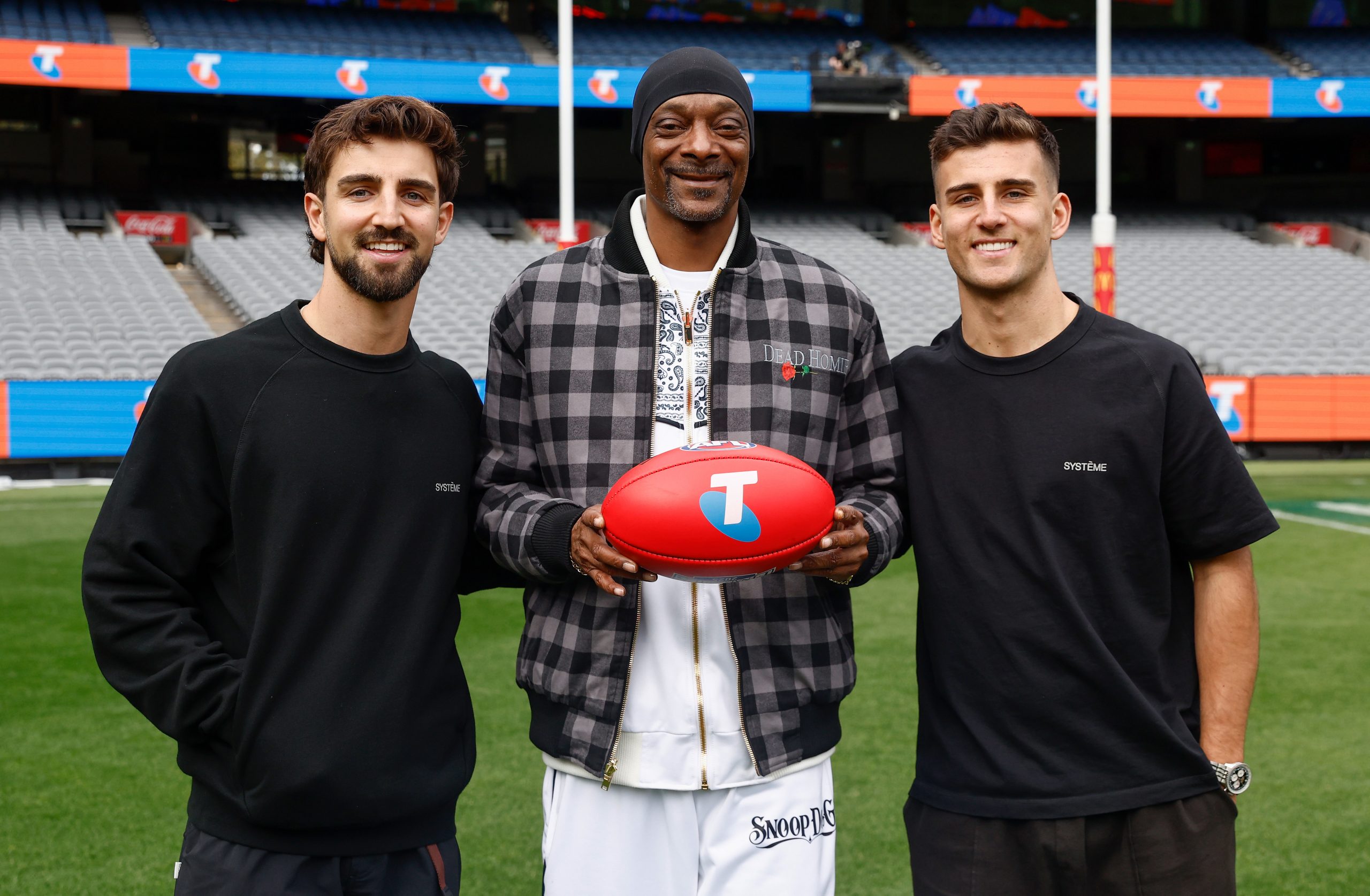 Snoop Dogg poses with Josh Daicos (left) and Nick Daicos of the Magpies during an AFL Telstra Grand Final Entertainment Media Opportunity at the MCG.