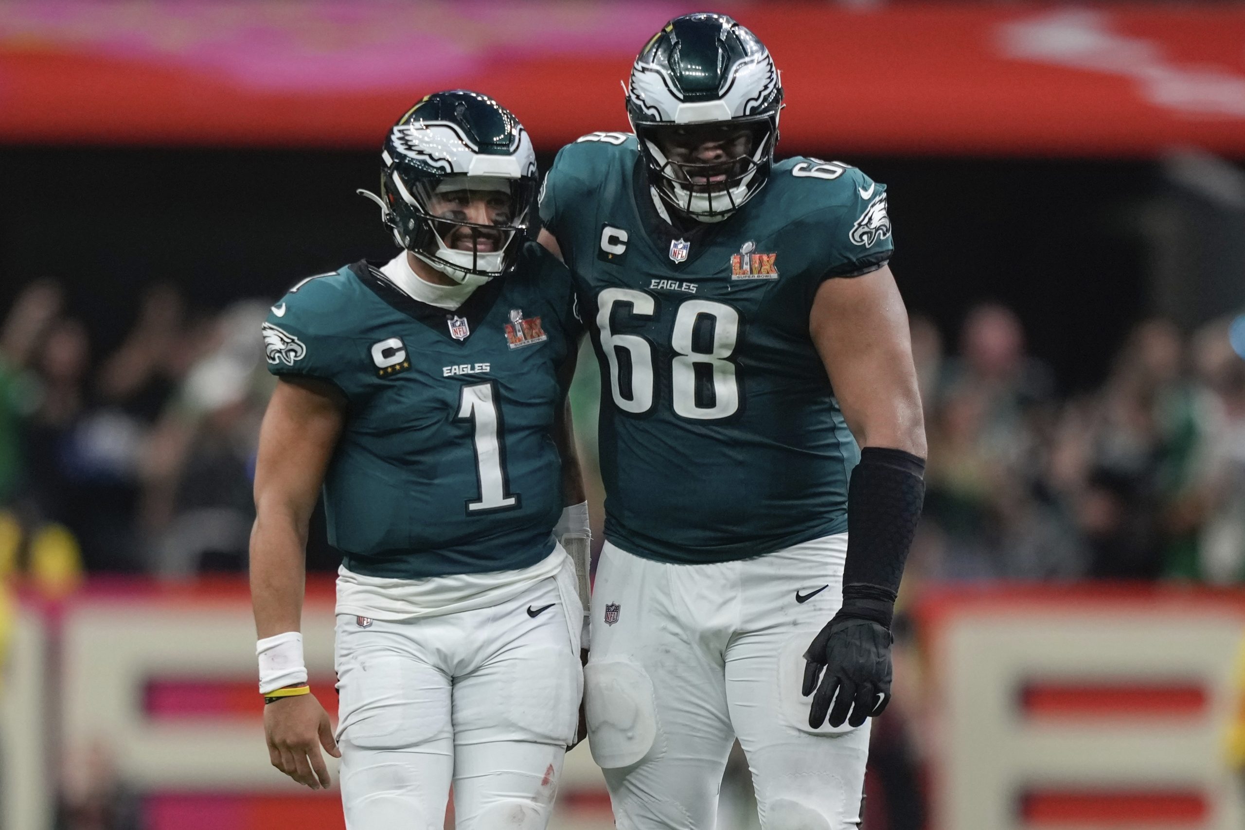 Philadelphia Eagles quarterback Jalen Hurts (1) is hugged by offensive tackle Jordan Mailata (68) after throwing a touchdown pass to wide receiver DeVonta Smith (6) during the second half of the NFL Super Bowl 59 football game, Sunday, Feb. 9, 2025, in New Orleans. (AP Photo/Matt Slocum)