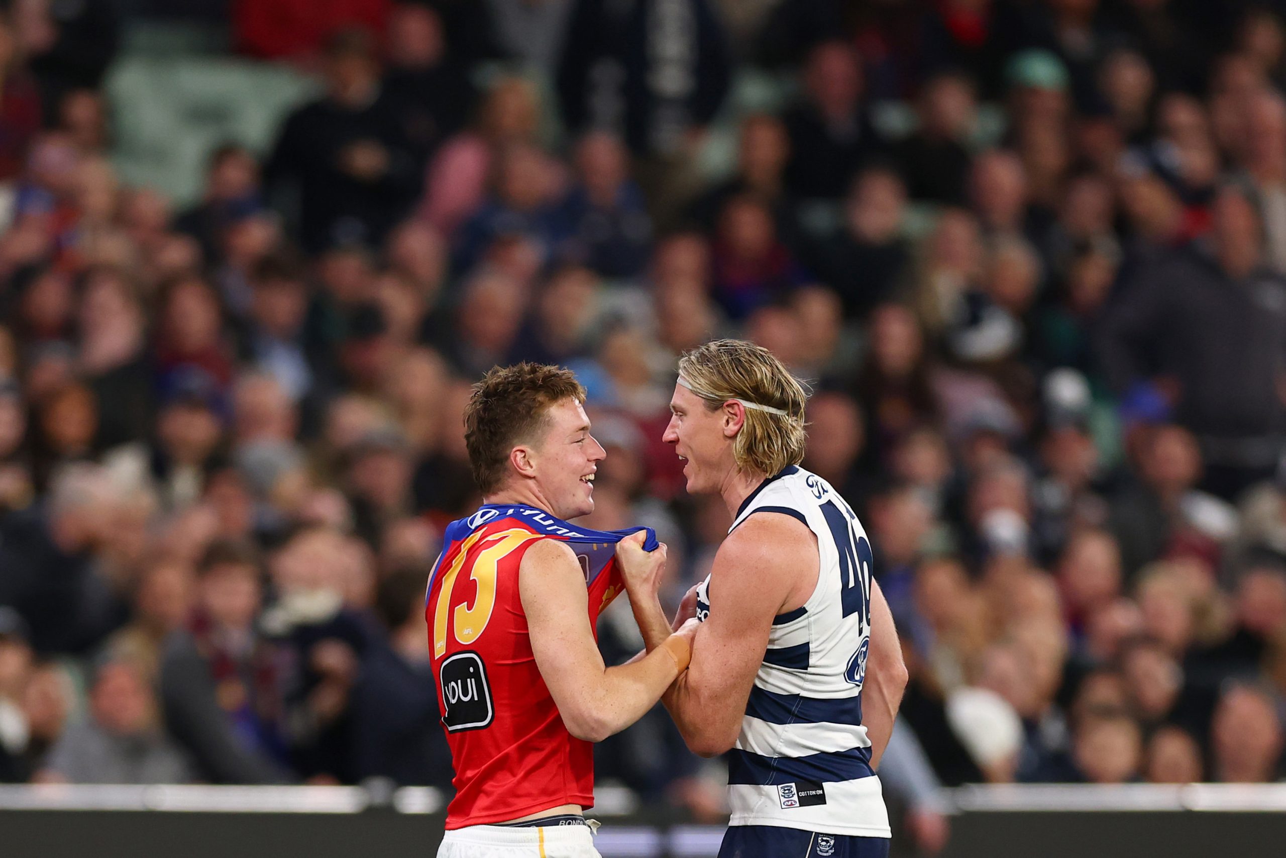 Logan Morris of the Lions and Mark Blicavs of the Cats exchange words