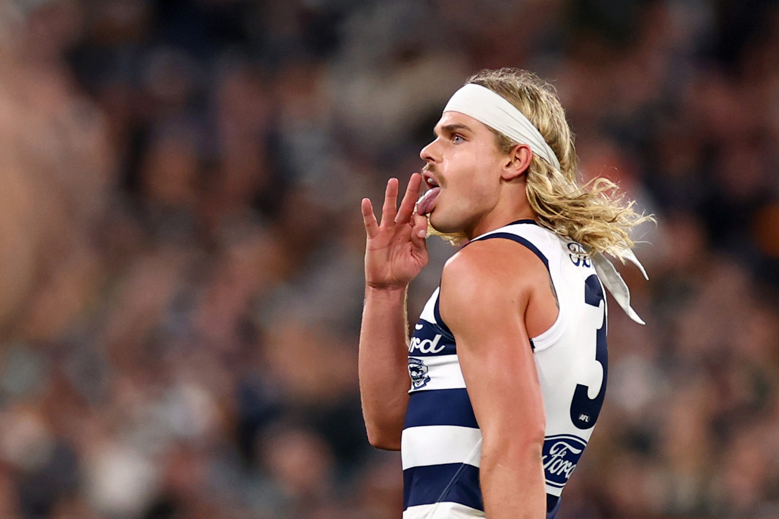 Bailey Smith of the Cats celebrates kicking a goal.