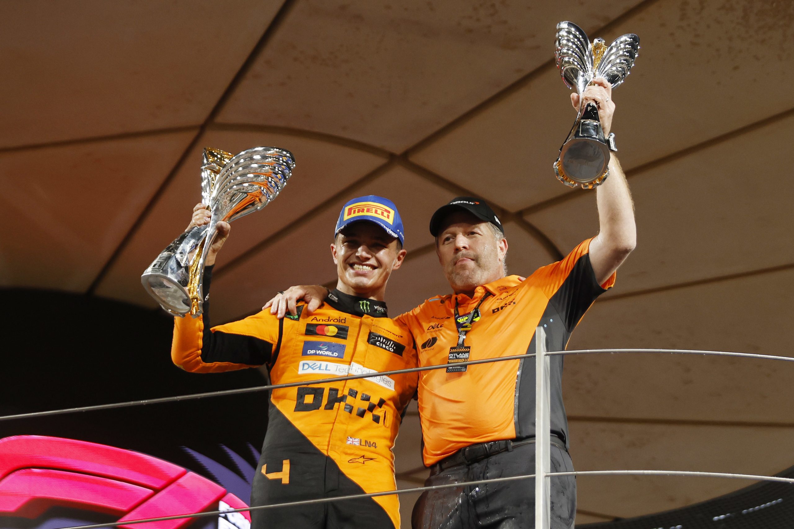 Lando Norris and Zak Brown on the podium with the trophies during F1 Grand Prix of Abu Dhabi.