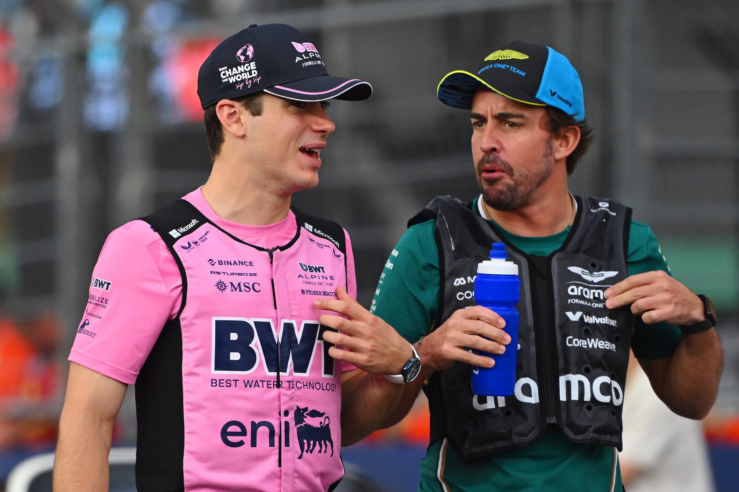Franco Colapinto and Fernando Alonso talk on the drivers parade prior to the F1 Grand Prix of Singapore.