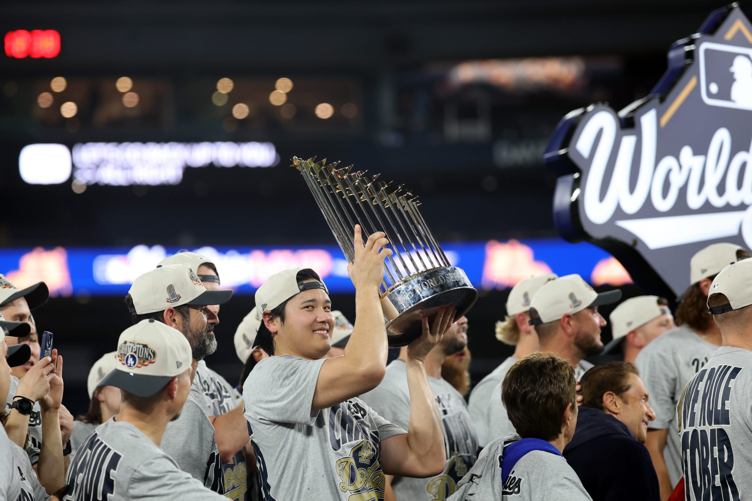 Shohei Ohtani of the Los Angeles Dodgers hoists the World Series Trophy.