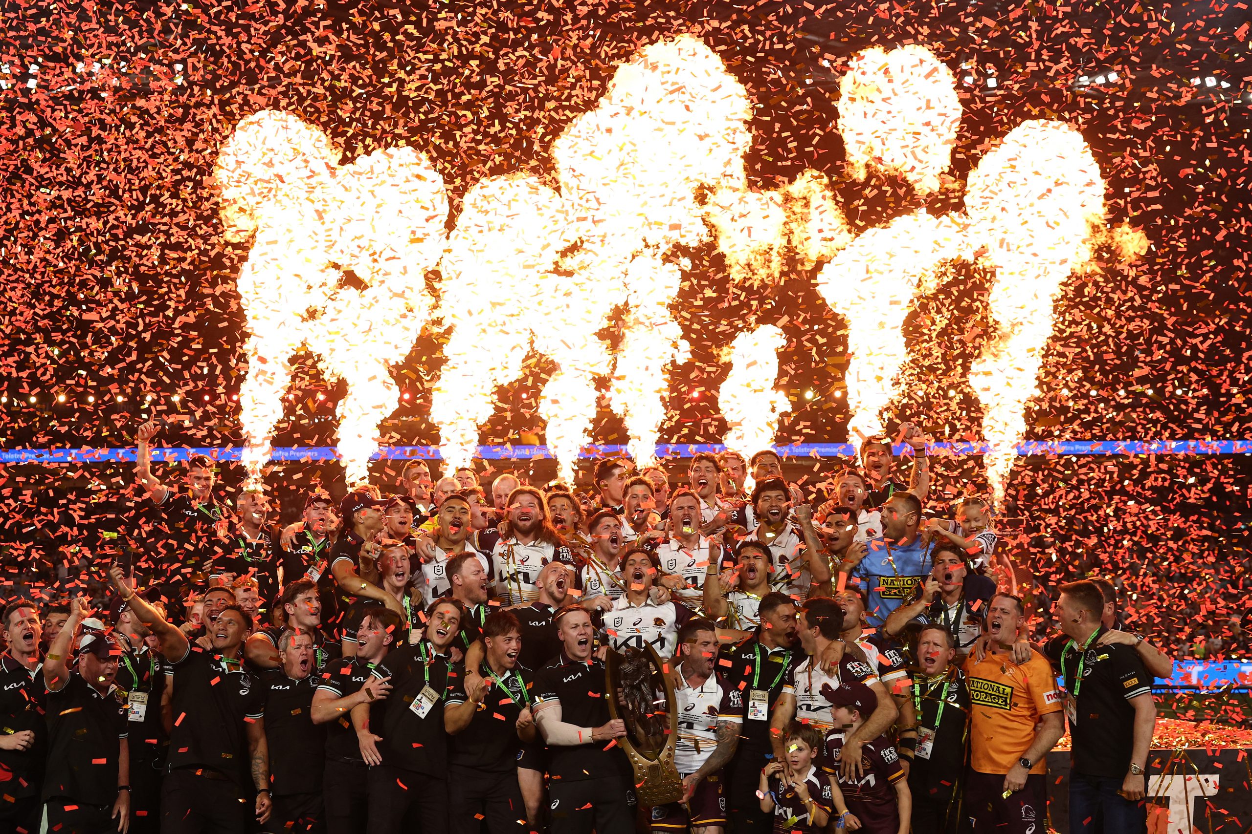 Adam Reynolds and Billy Walters of the Broncos hold aloft the Provan-Summons Trophy as the team celebrates after winning the NRL Grand Final match between the Melbourne Storm at Brisbane Broncos at Accor Stadium on October 05, 2025, in Sydney, Australia.