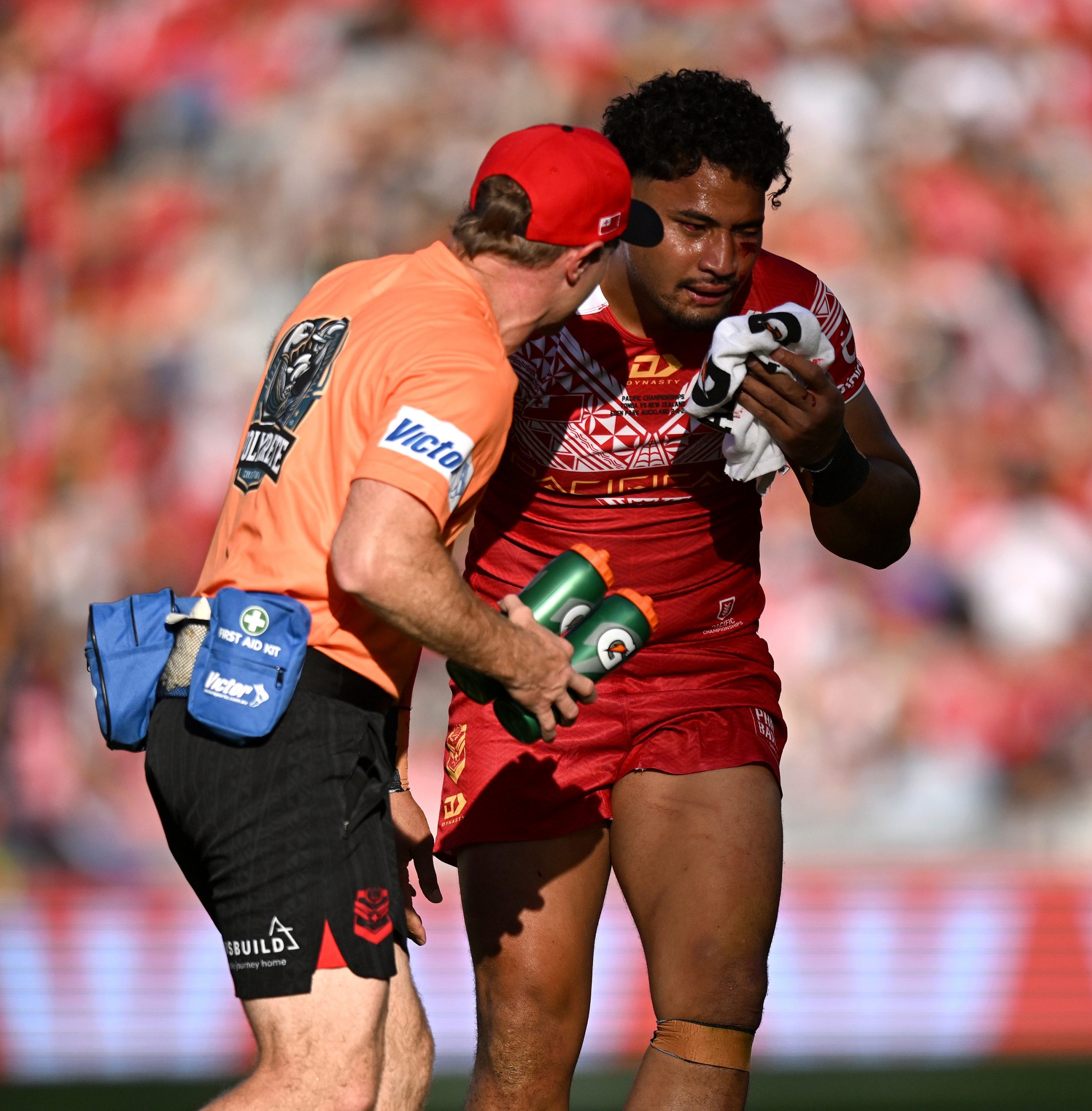 Eli Katoa is assisted by trainers after copping a brutal knock to the head by a teammate.
