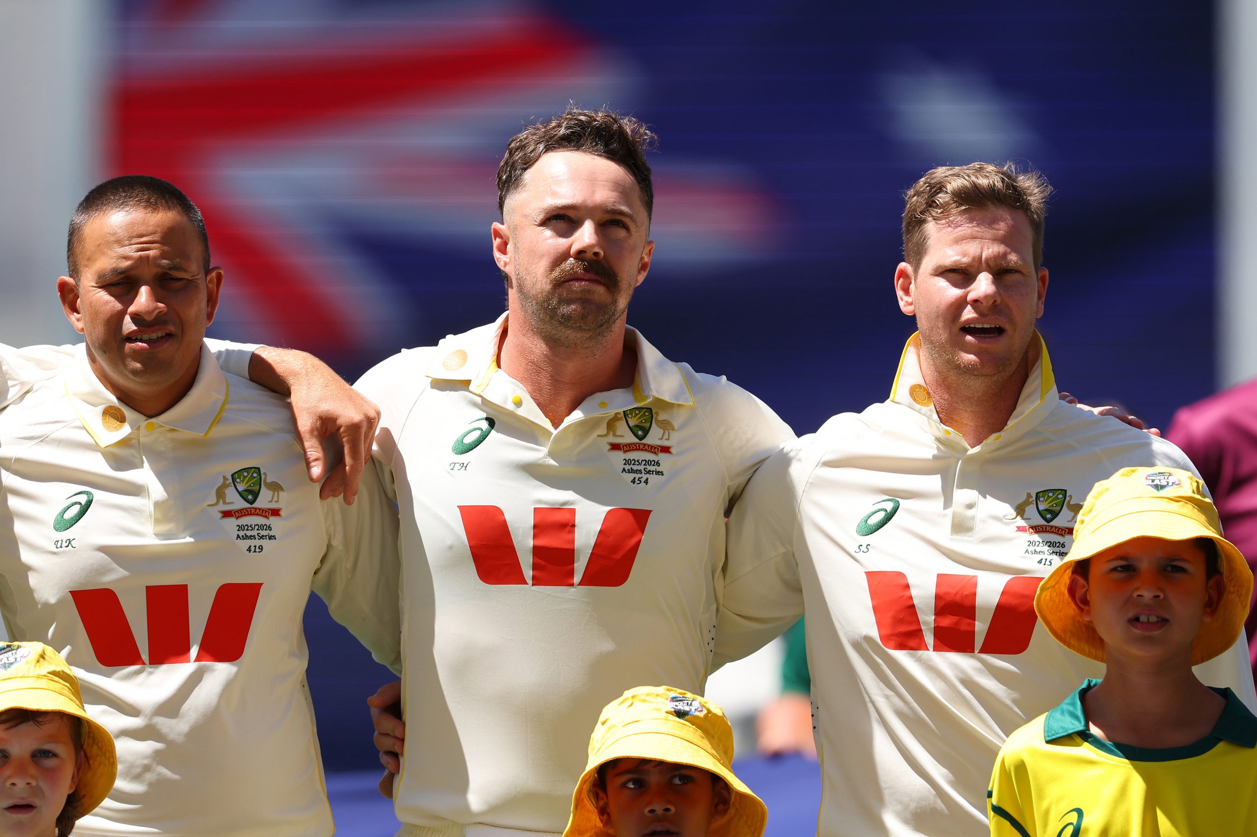 PERTH, AUSTRALIA - NOVEMBER 21: Usman Khawaja, Travis Head and Steve Smith of Australia sing the national anthem during day one of the First 2025/26 Ashes Series Test Match between Australia and England at Perth Stadium on November 21, 2025 in Perth, Australia. (Photo by Paul Kane - CA/Cricket Australia via Getty Images)