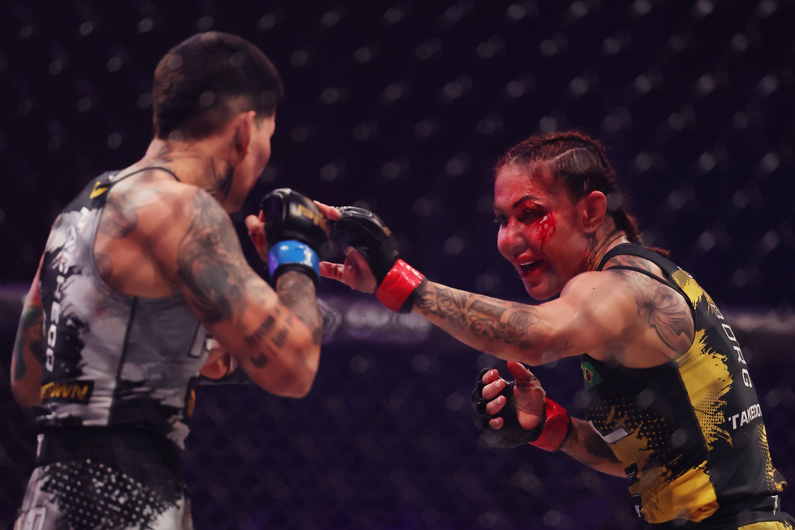 Cris Cyborg with a bloodied face competes against Larissa Pacheco.