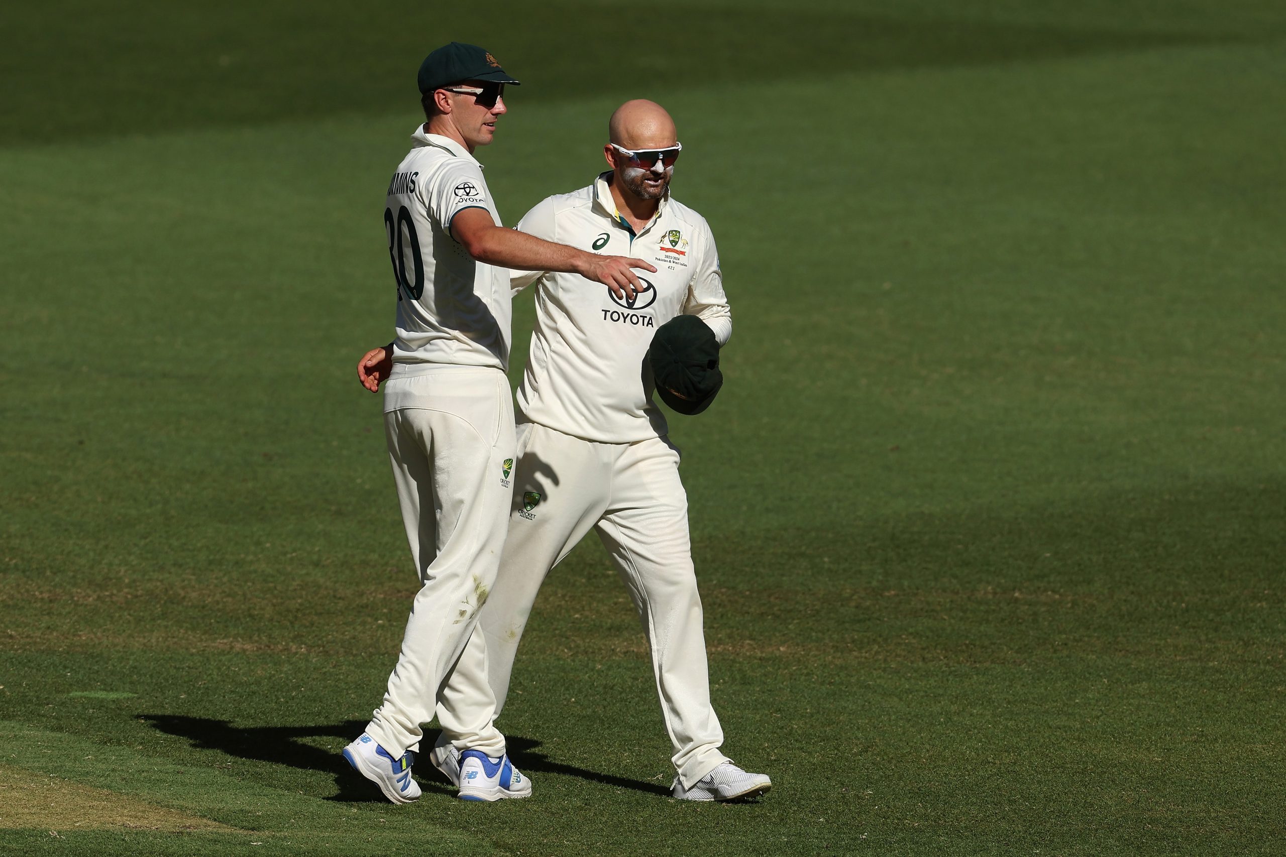 PERTH, AUSTRALIA - DECEMBER 17: Nathan Lyon of Australia celebrates with Australian captain Pat Cummins after dismissing Faheem Ashraf of Pakistan following a DRS review and taking his 500th test wicket during day four of the Men's First Test match between Australia and Pakistan at Optus Stadium on December 17, 2023 in Perth, Australia (Photo by Paul Kane/Getty Images)